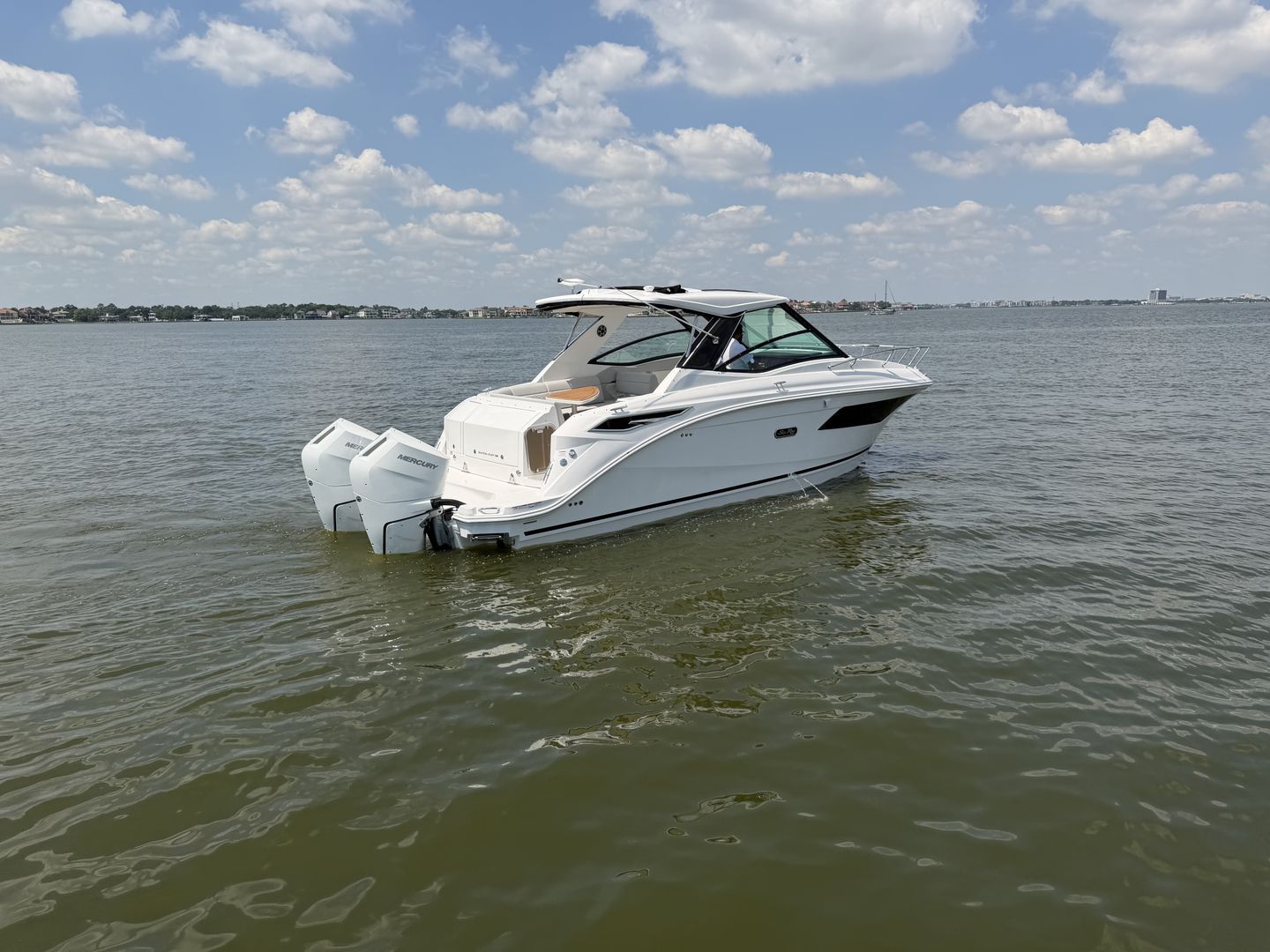 2026 Sea Ray Sundancer 320 Outboard on calm waters.