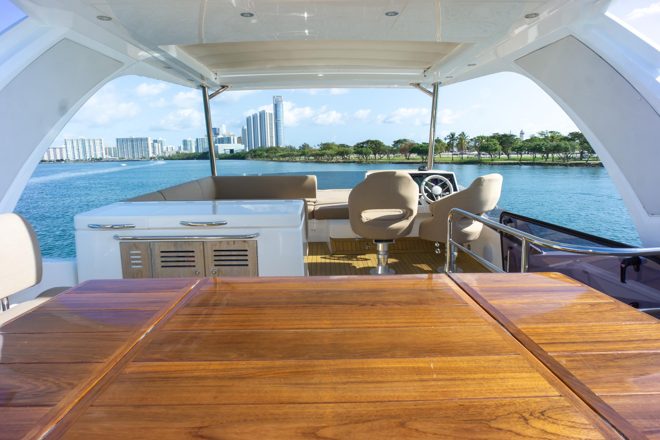 Luxurious 2018 Sunseeker Manhattan 52 yacht interior with scenic waterfront view.