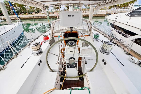 Cockpit of a 1989 Concordia 52 sailboat with steering wheel and navigation equipment.