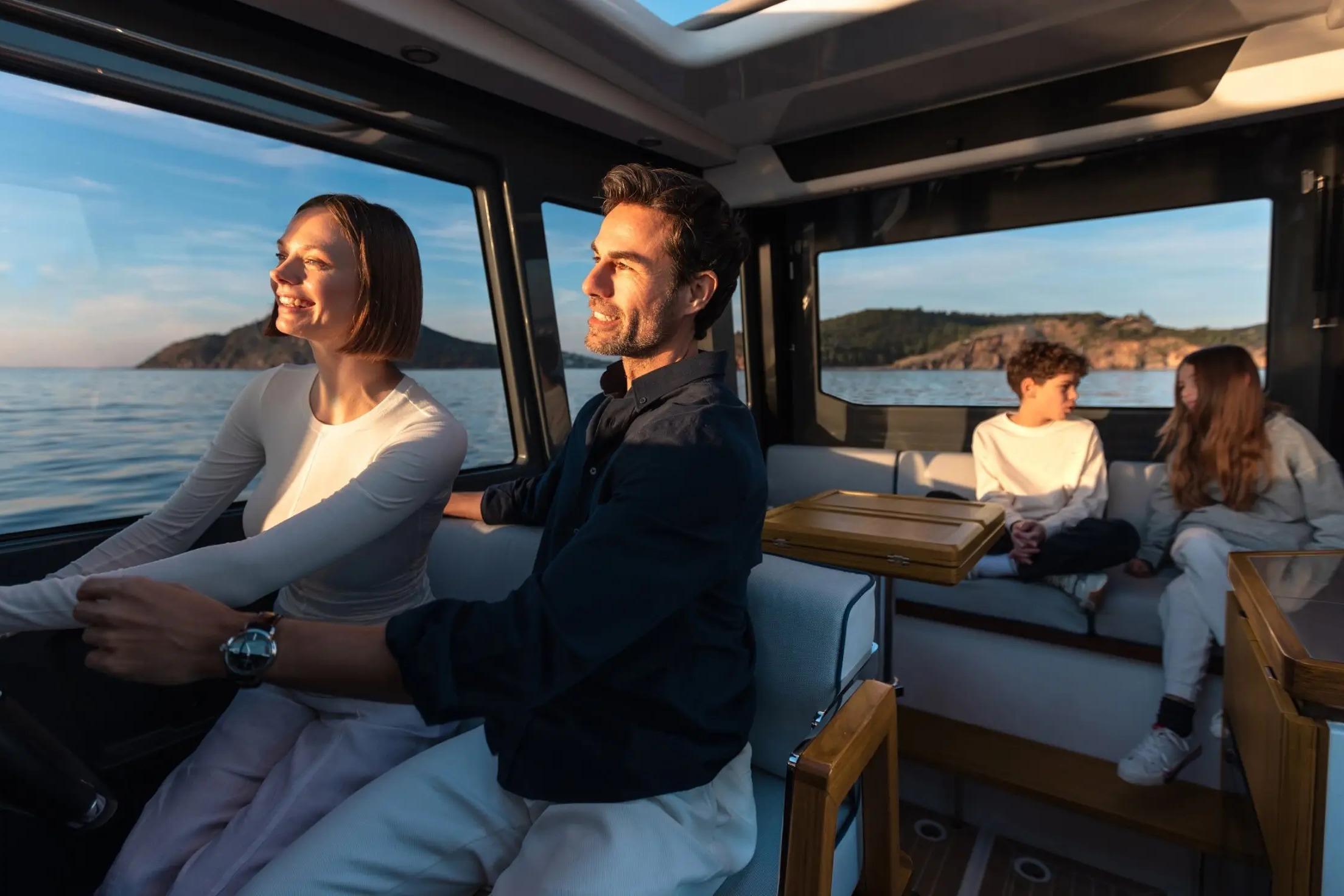 Family enjoying sunset cruise on Aiata Wayfinder 38 Cabin, 2026 model.