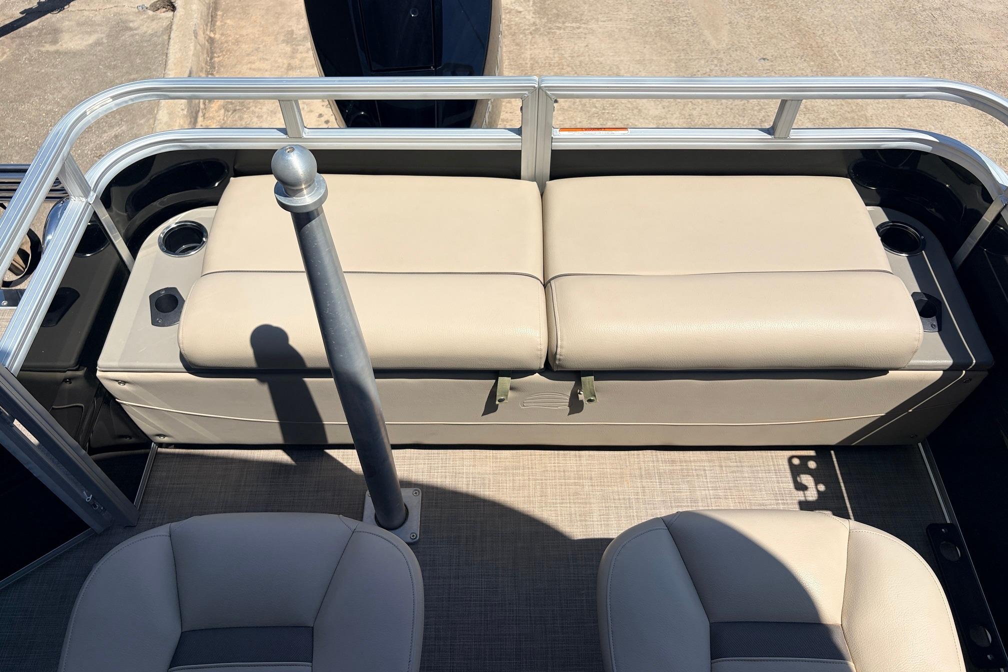 2024 Sun Tracker SportFish 22 XP3 boat interior with beige seating and cup holders.