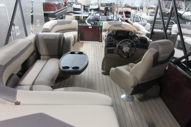 2022 Sylvan L-1 Cruise pontoon boat interior with beige seating and steering console.