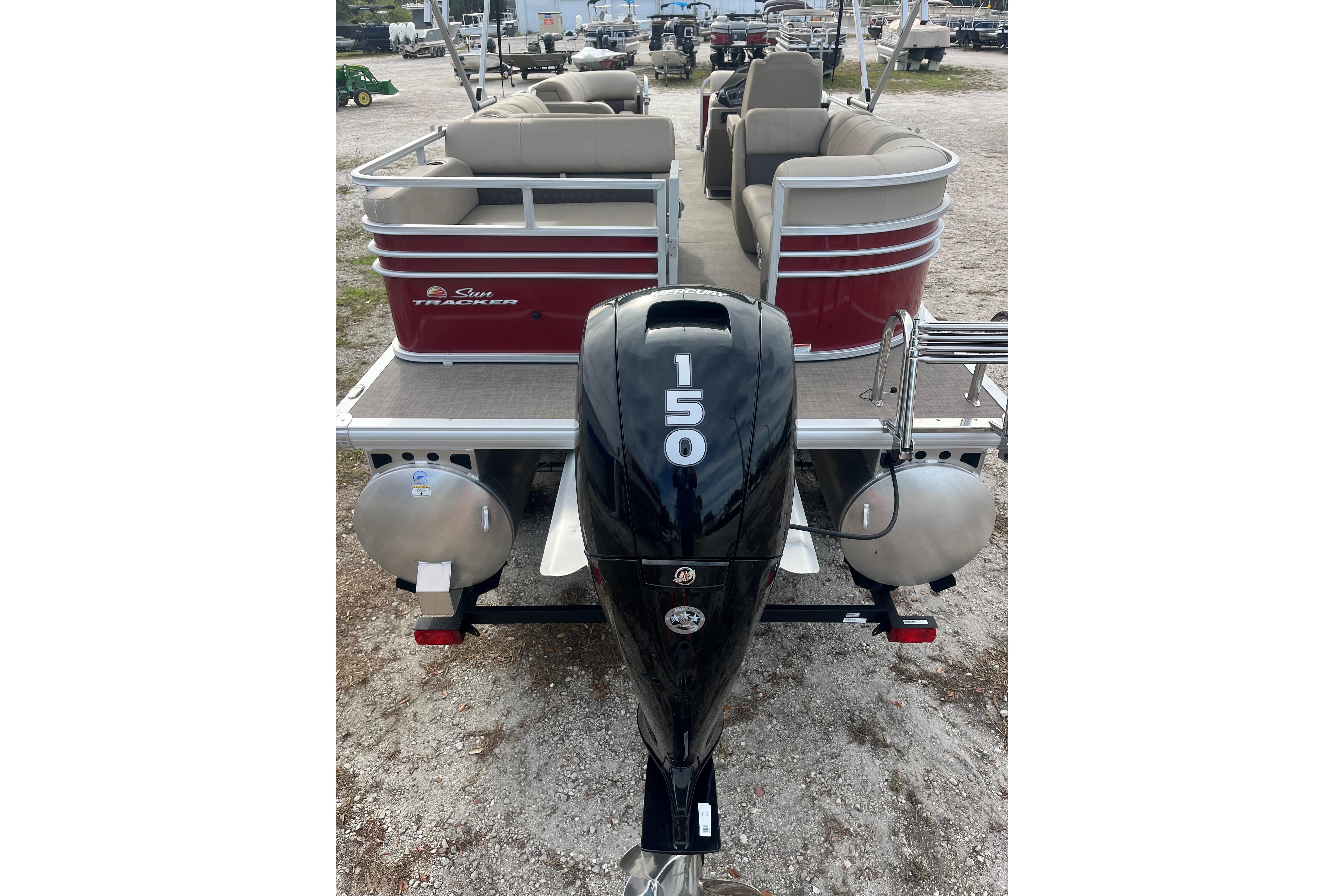 2023 Sun Tracker Party Barge 22 RF DLX with 150 HP engine, rear view.