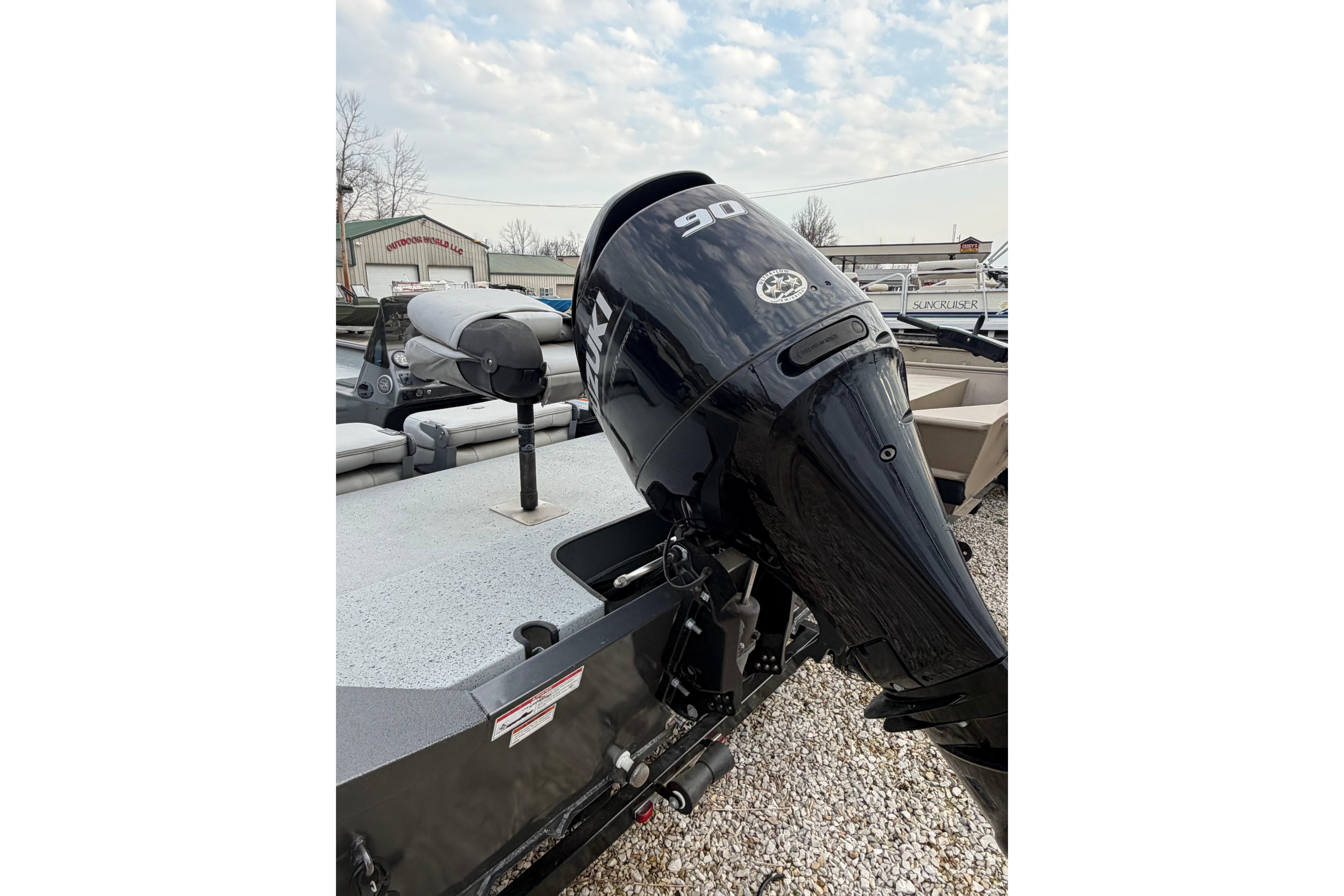 2023 SeaArk 180 RX boat with a 90 HP outboard motor, parked outdoors.