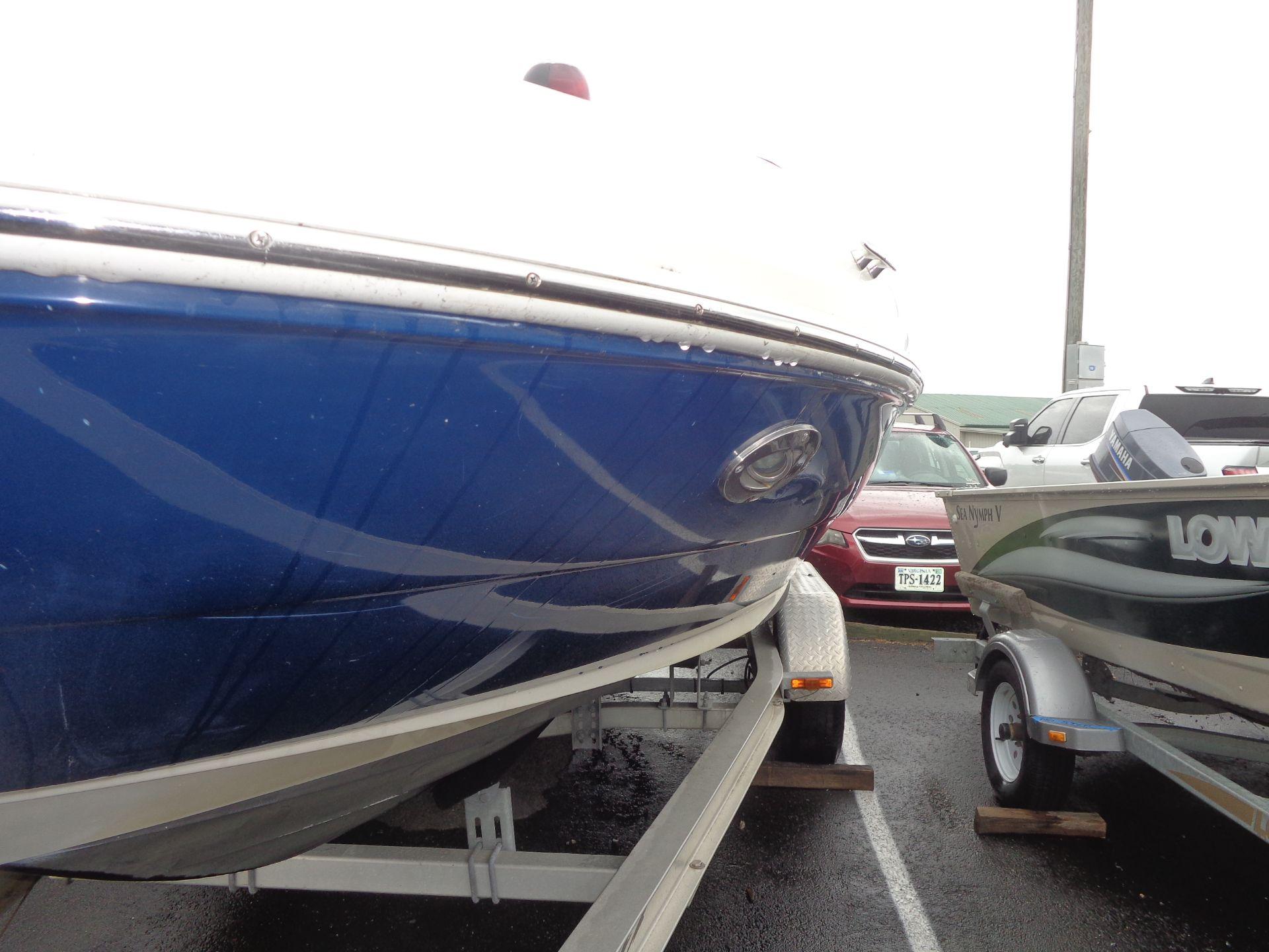 2007 Sea Ray 200 Sundeck boat on trailer in parking lot.