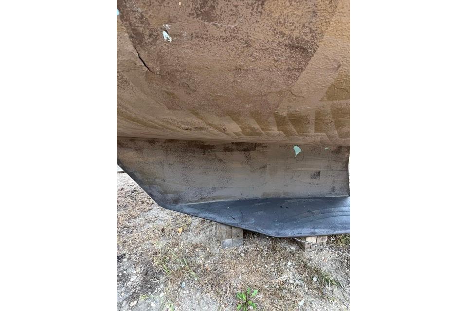 Bottom view of a 1999 Catalina 34 MkII sailboat hull on dry land.