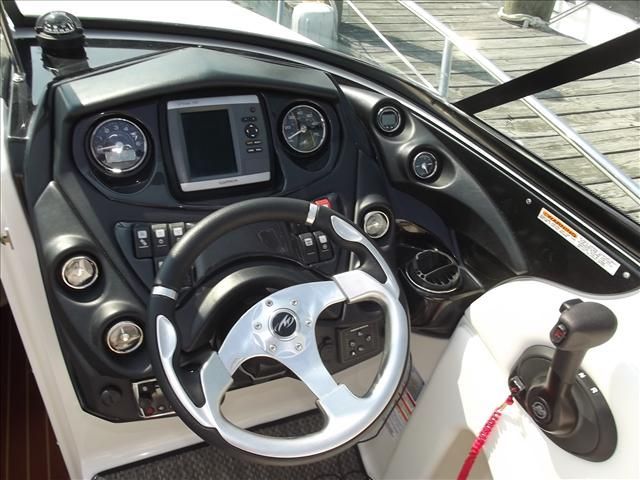 The cockpit of a Monterey 264 boat with steering wheel and instruments.