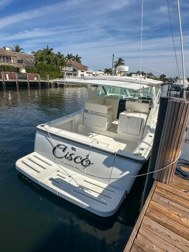 2006 Tiara Yachts 3200 Open docked in a marina under a clear blue sky.
