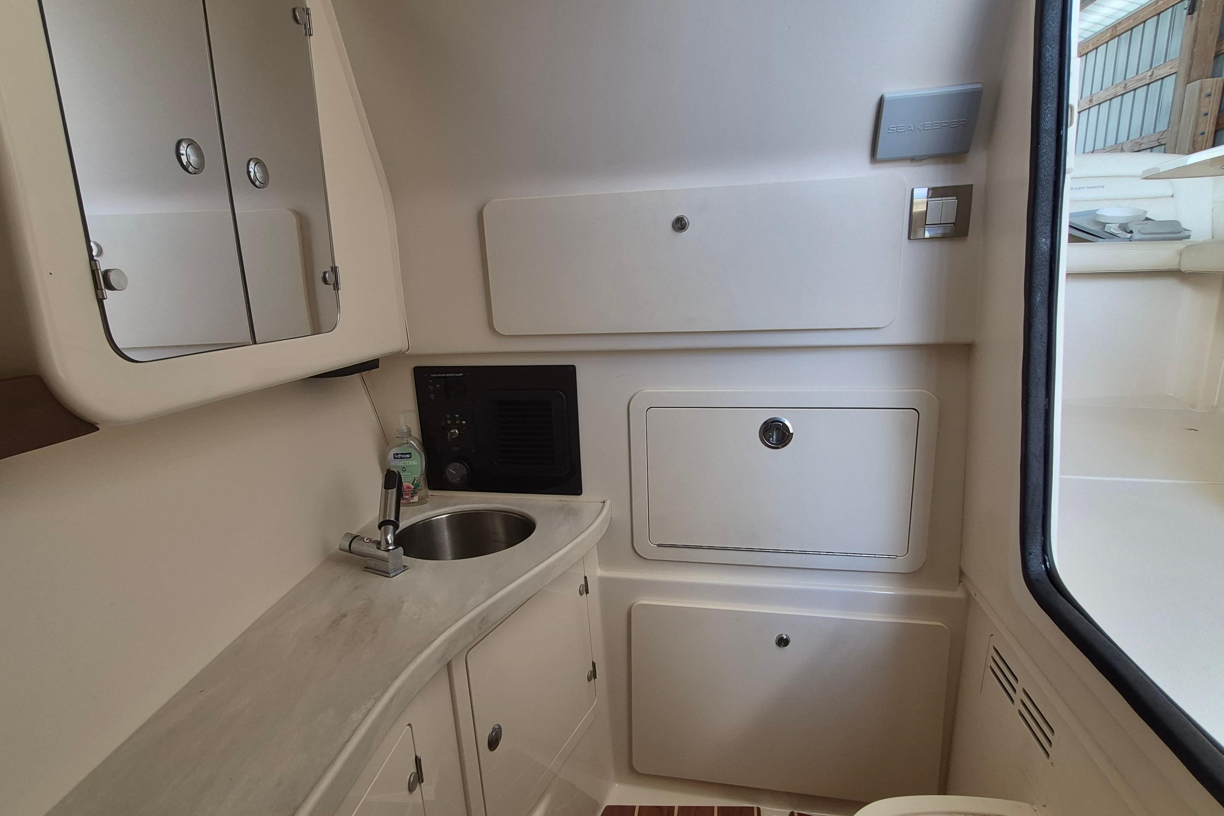 2019 Grady-White Freedom 335 boat interior with sink and storage compartments.