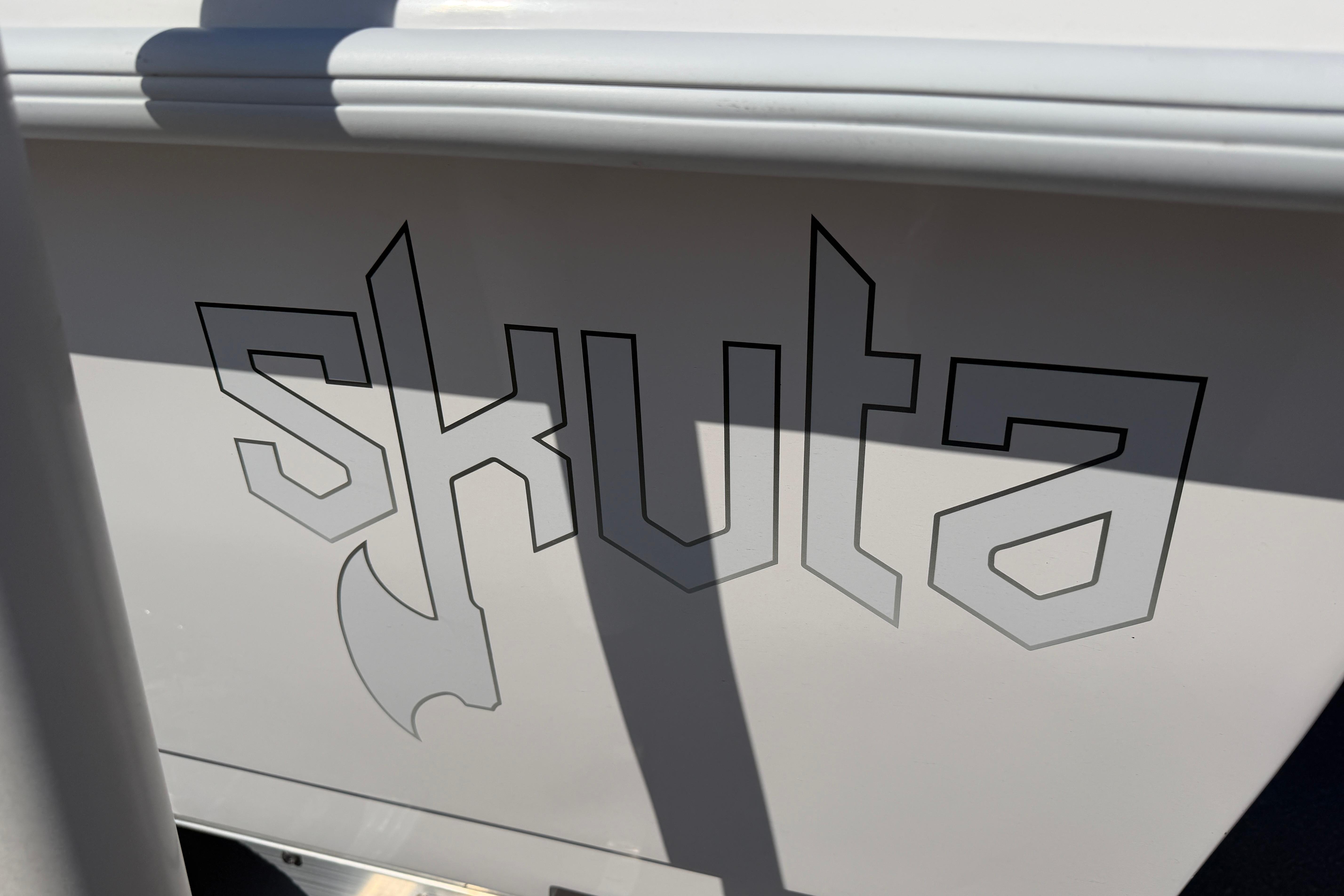 Skuta 24 Cat 2026 model logo on boat exterior, featuring bold, angular lettering.