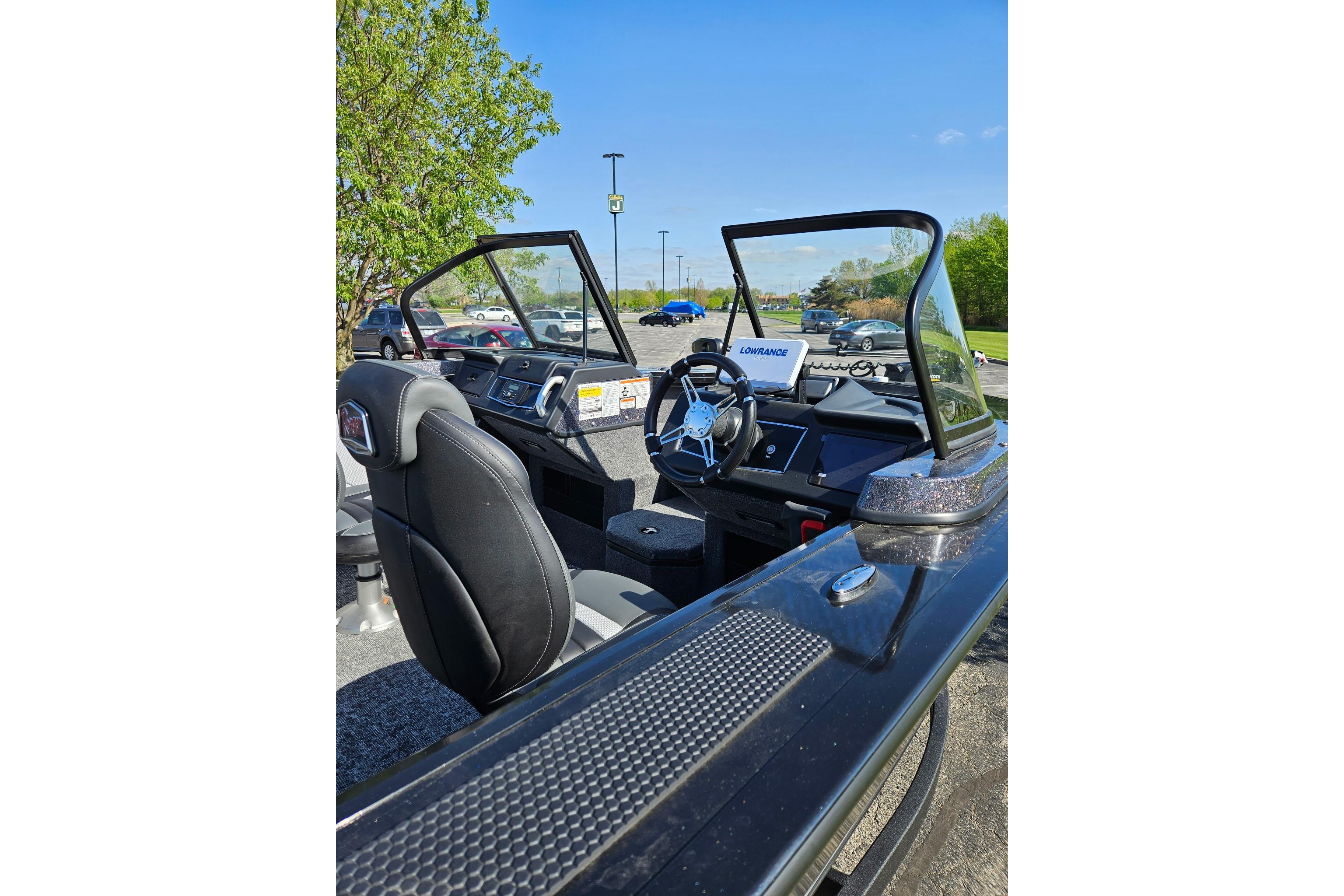 2026 Ranger VX1888 WT boat interior with steering wheel and dashboard, parked outdoors.