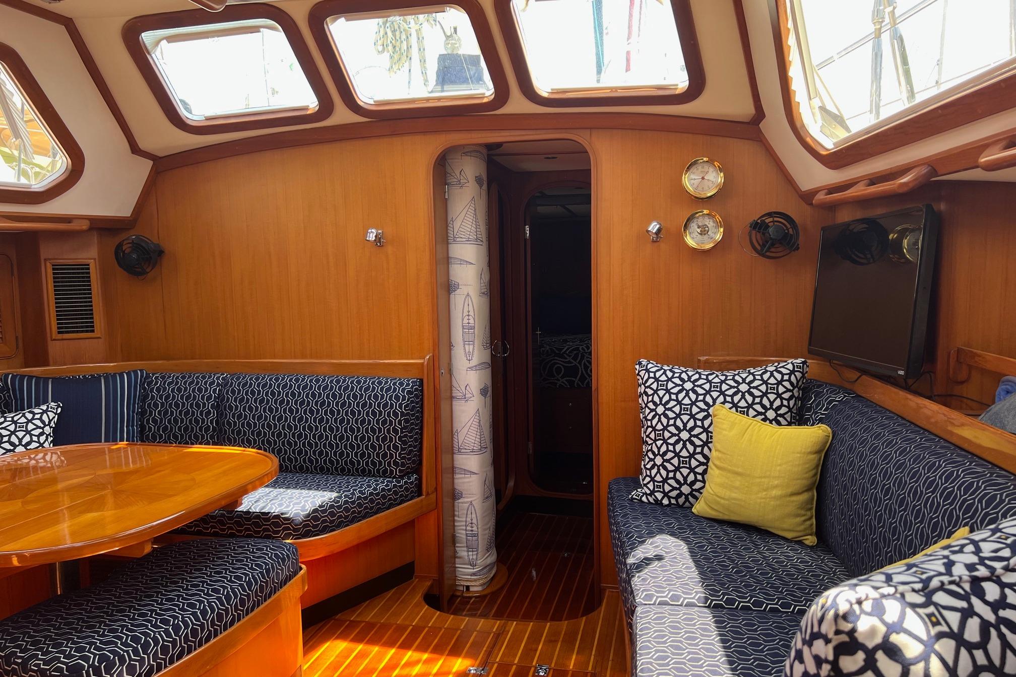 Luxurious interior of a 2000 Hylas Raised Salon yacht with elegant wood finish.