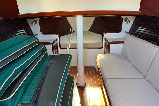 Interior of a 2006 Morris 36 sailboat with cushions and wooden accents.
