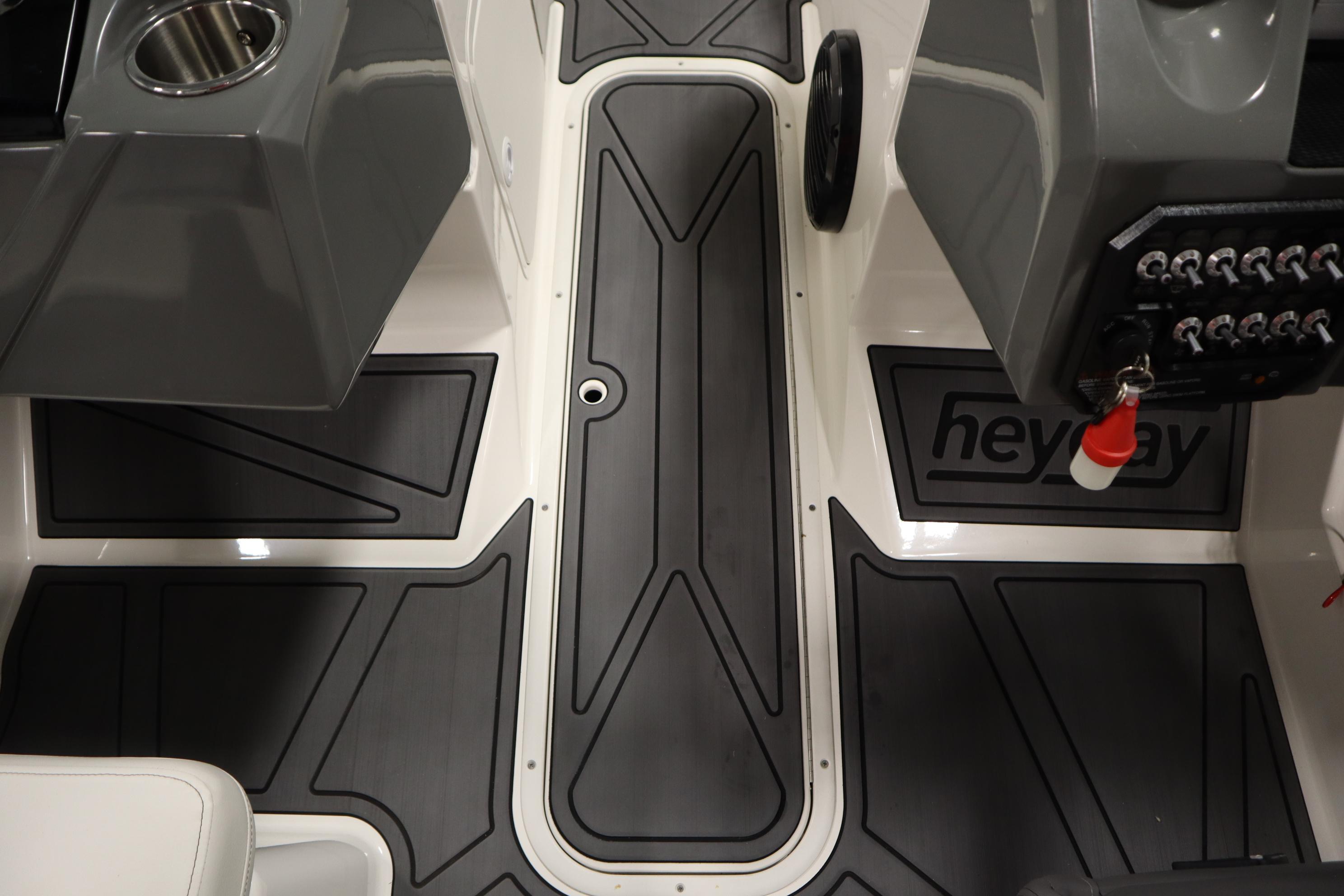 2023 Heyday WT Surf boat interior with sleek black flooring and control panel.