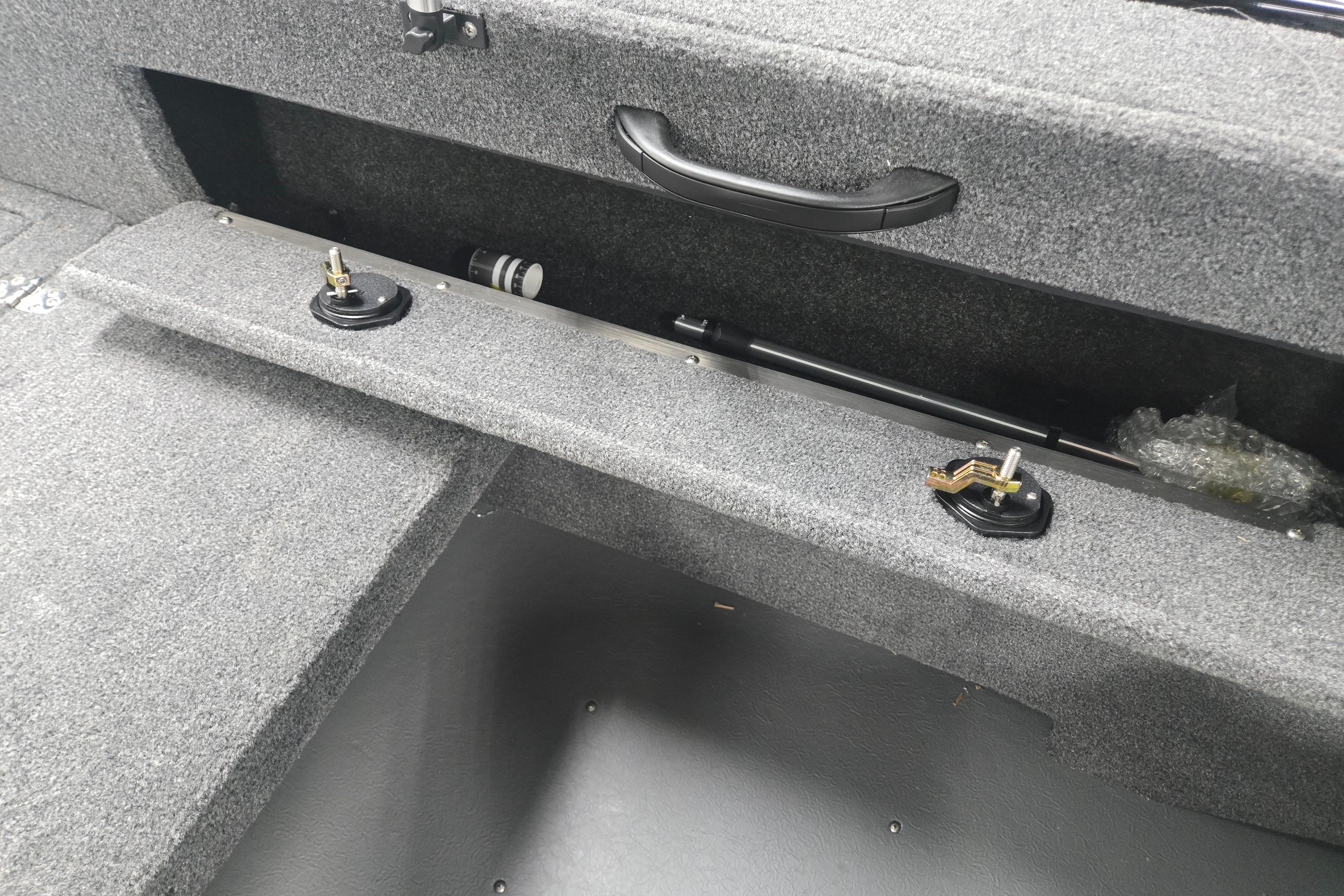 Interior storage compartment of 2026 Princecraft Sport 175 MAX boat, featuring carpeted finish.