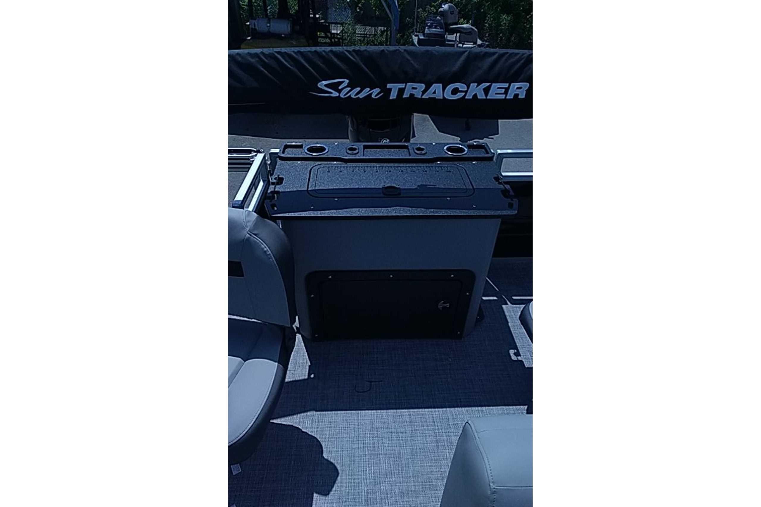 2026 Sun Tracker SportFish 22 DLX boat interior with seating and storage area.