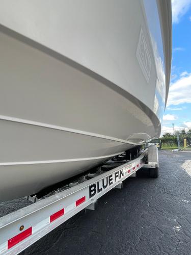 2014 Everglades 325 Center Console boat on Blue Fin trailer, side view.