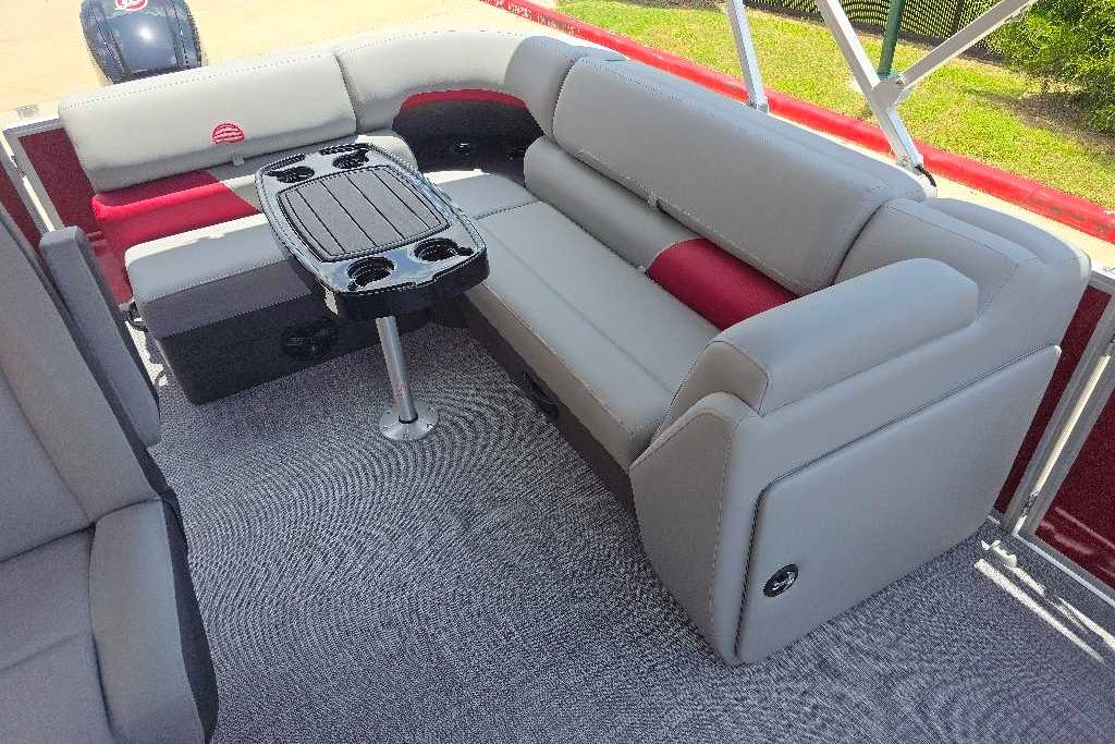 2026 Sun Tracker Party Barge 20 DLX interior with plush seating and central table.
