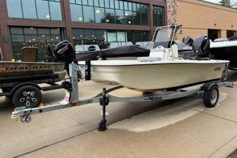2025 Mako Pro Skiff 13 CC boat on trailer, parked outdoors.