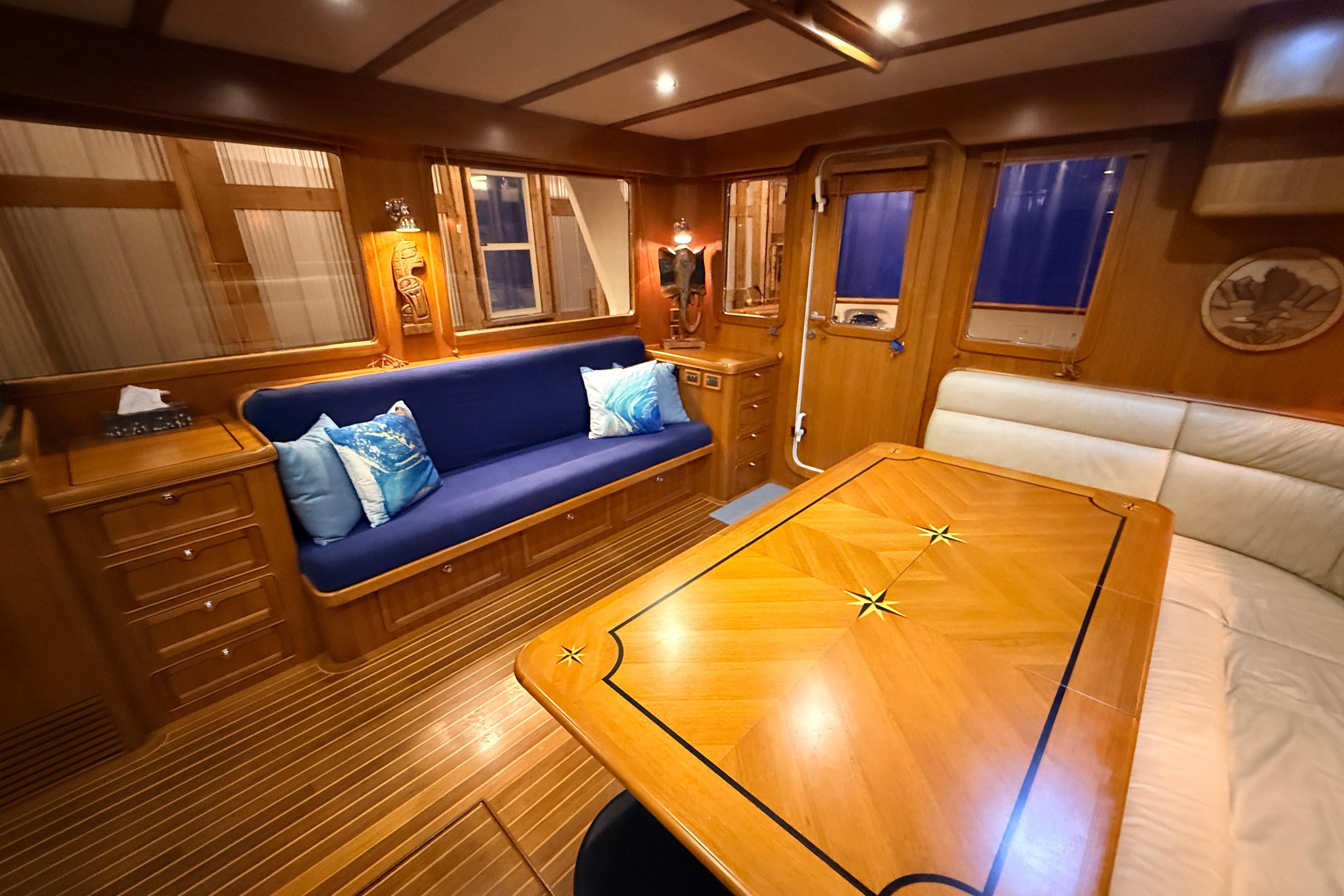 Luxurious interior of a 2006 Selene 57 yacht with elegant wood finishes and cozy seating.