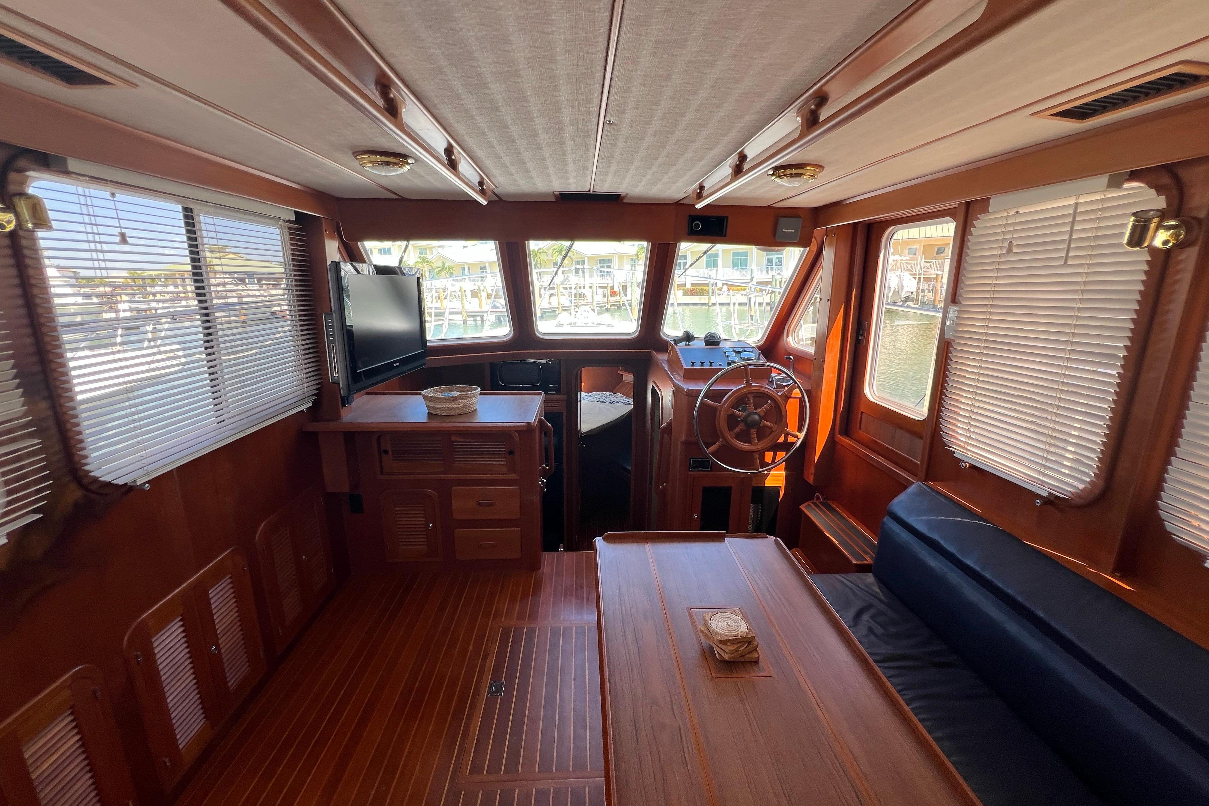 Interior of 2007 Heritage East 36 Sundeck Trawler with wood finish and helm station.
