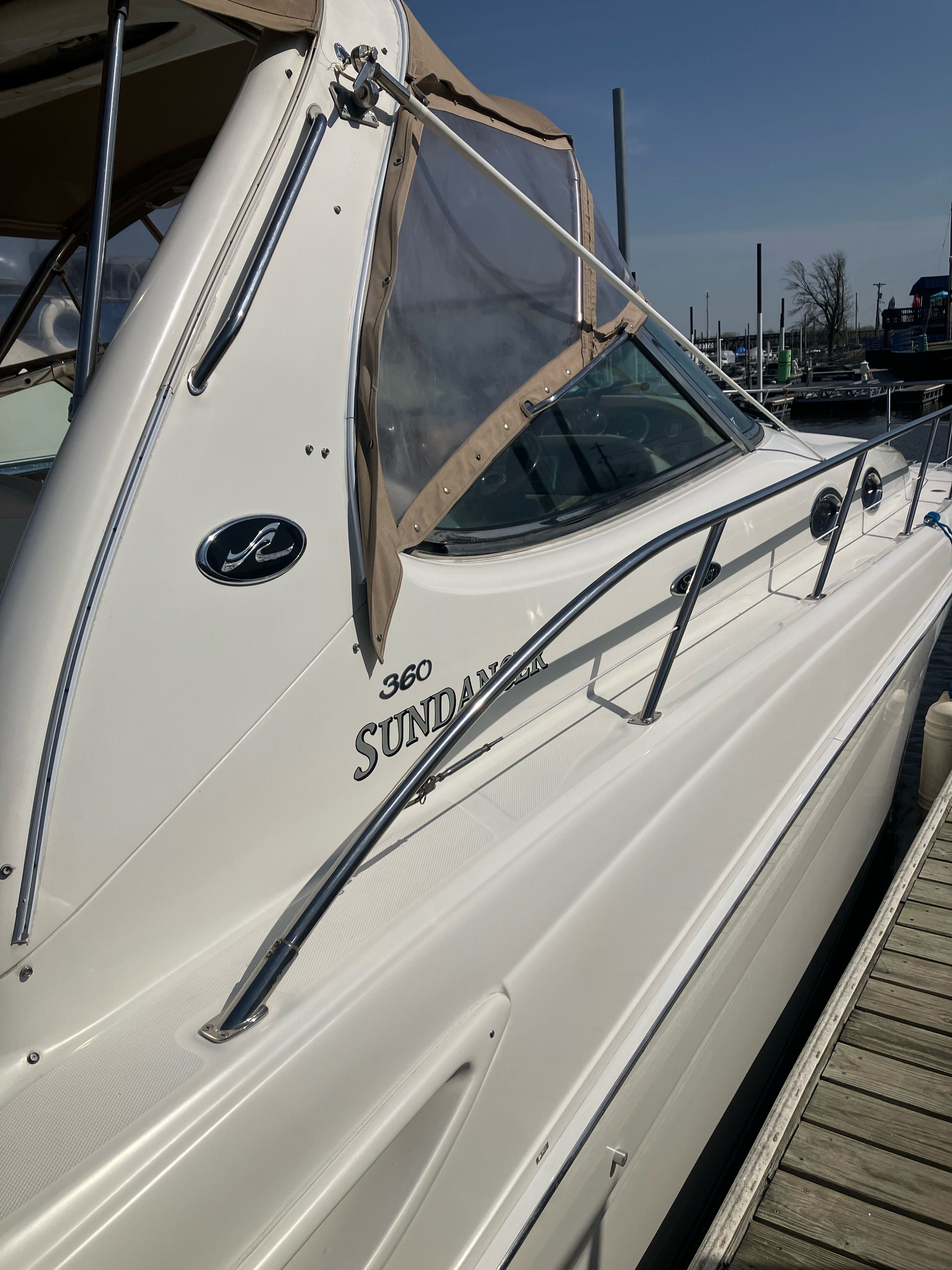 2002 Sea Ray 360 Sundancer at dock, side view.