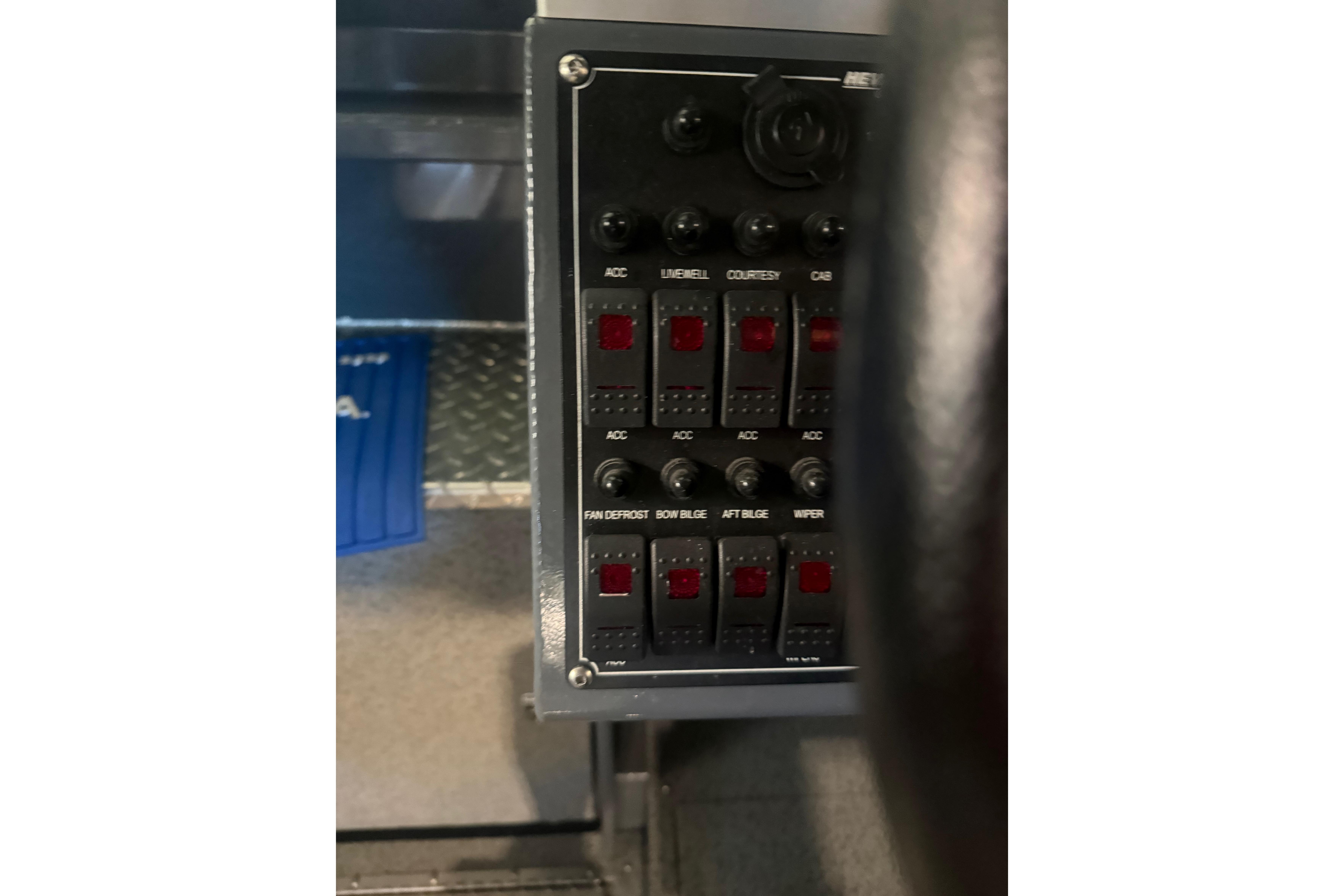 Control panel of a 2022 Hewescraft 270 Alaskan Hardtop boat, featuring various switches.