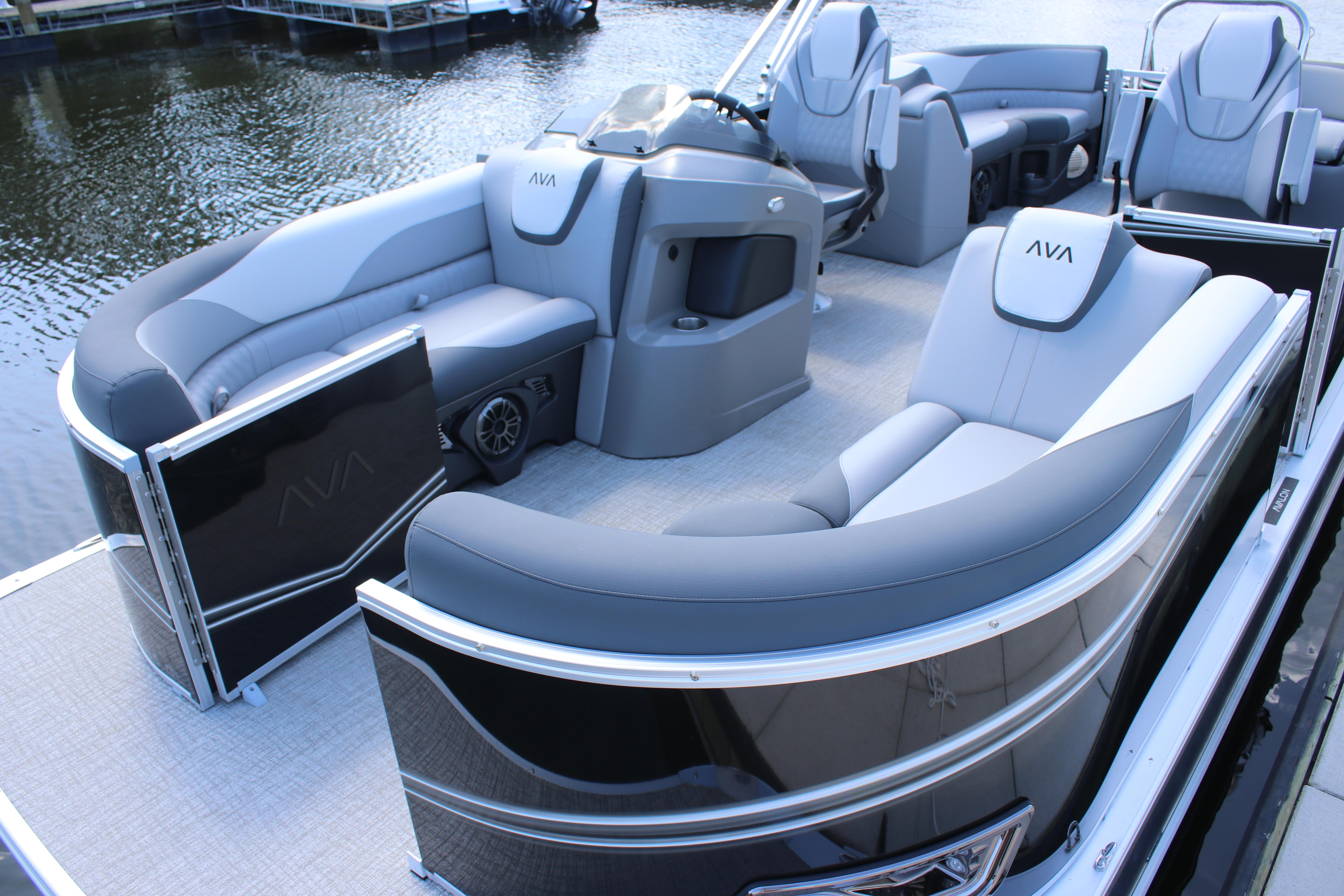 2025 Avalon LSZ Quad Lounger pontoon boat with luxurious seating on a calm lake.