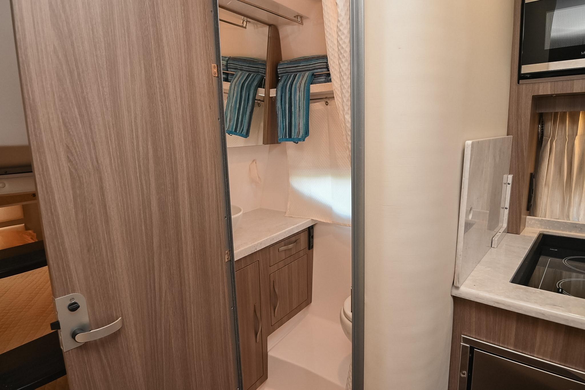 2021 Regal 33 Express yacht interior with modern kitchenette and compact bathroom.