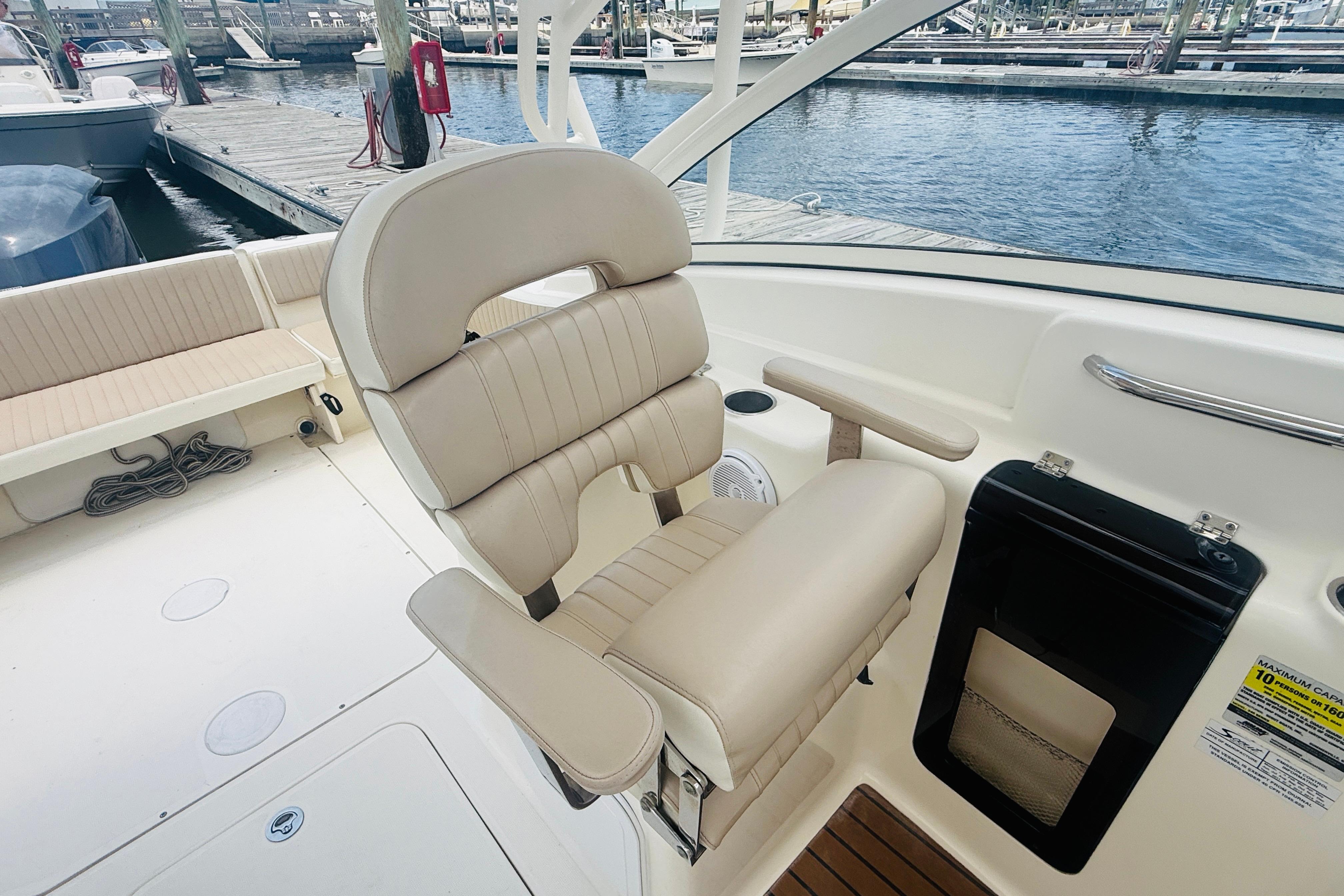 Luxurious seating on a 2012 Scout 245 Dorado boat at a marina.