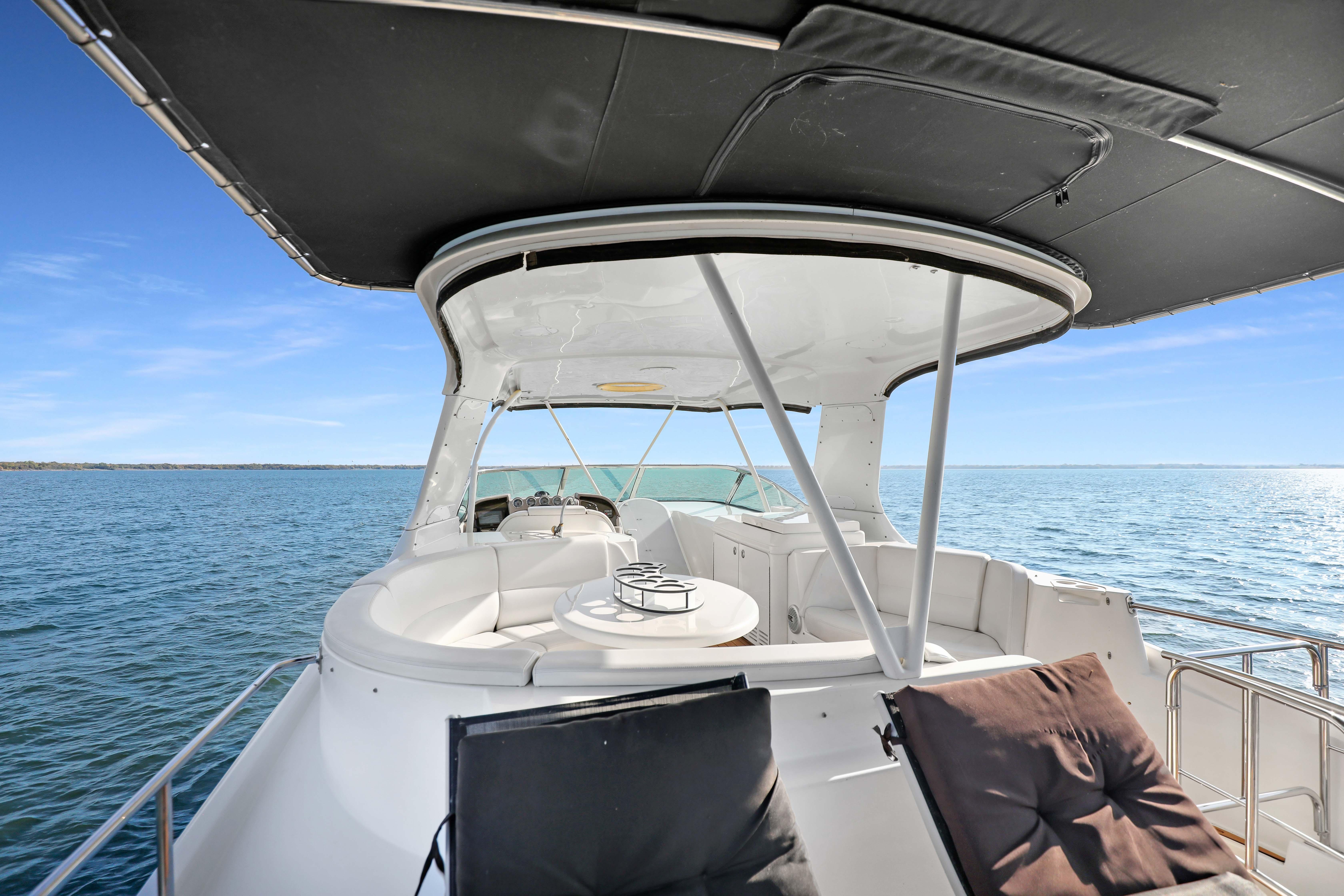 2005 Carver 560 Voyager yacht with spacious deck, cruising on open water.