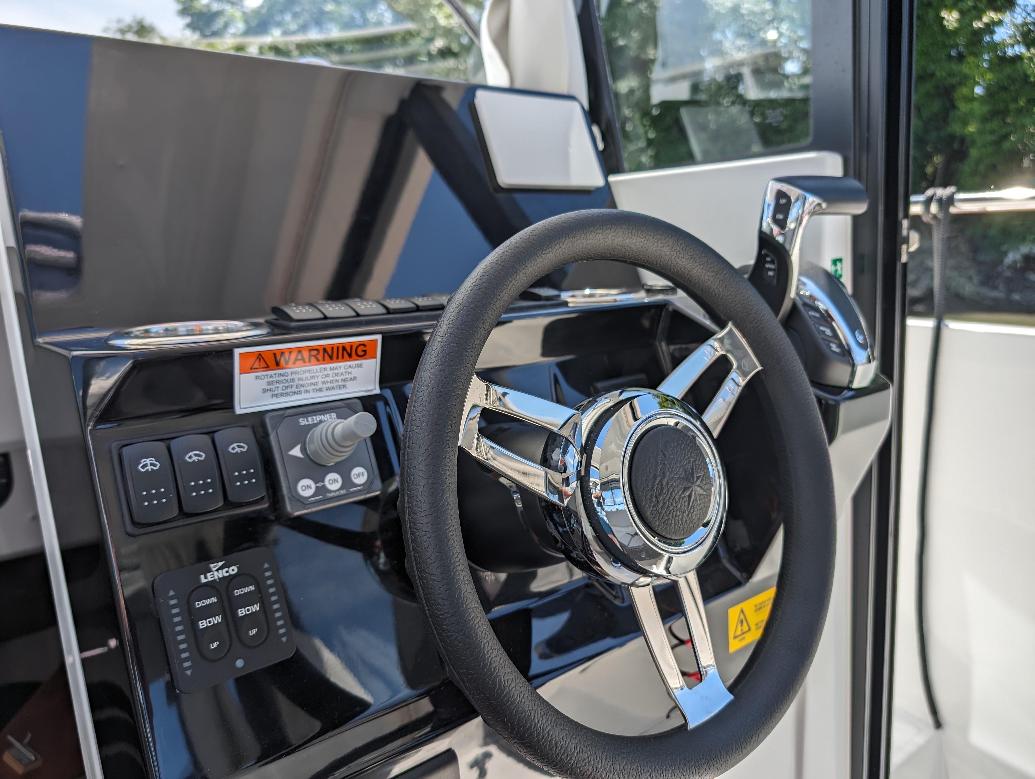 2024 Jeanneau NC Sport 795 Series 2 helm with steering wheel and controls.