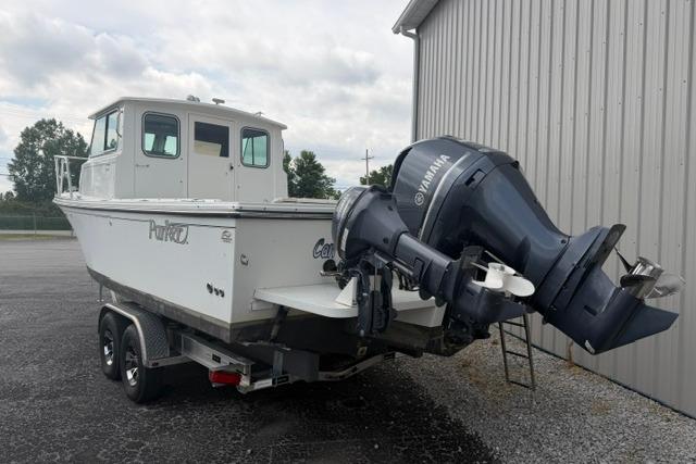 2016 Parker 2520 Sport Cabin boat with Yamaha outboard motor on trailer.