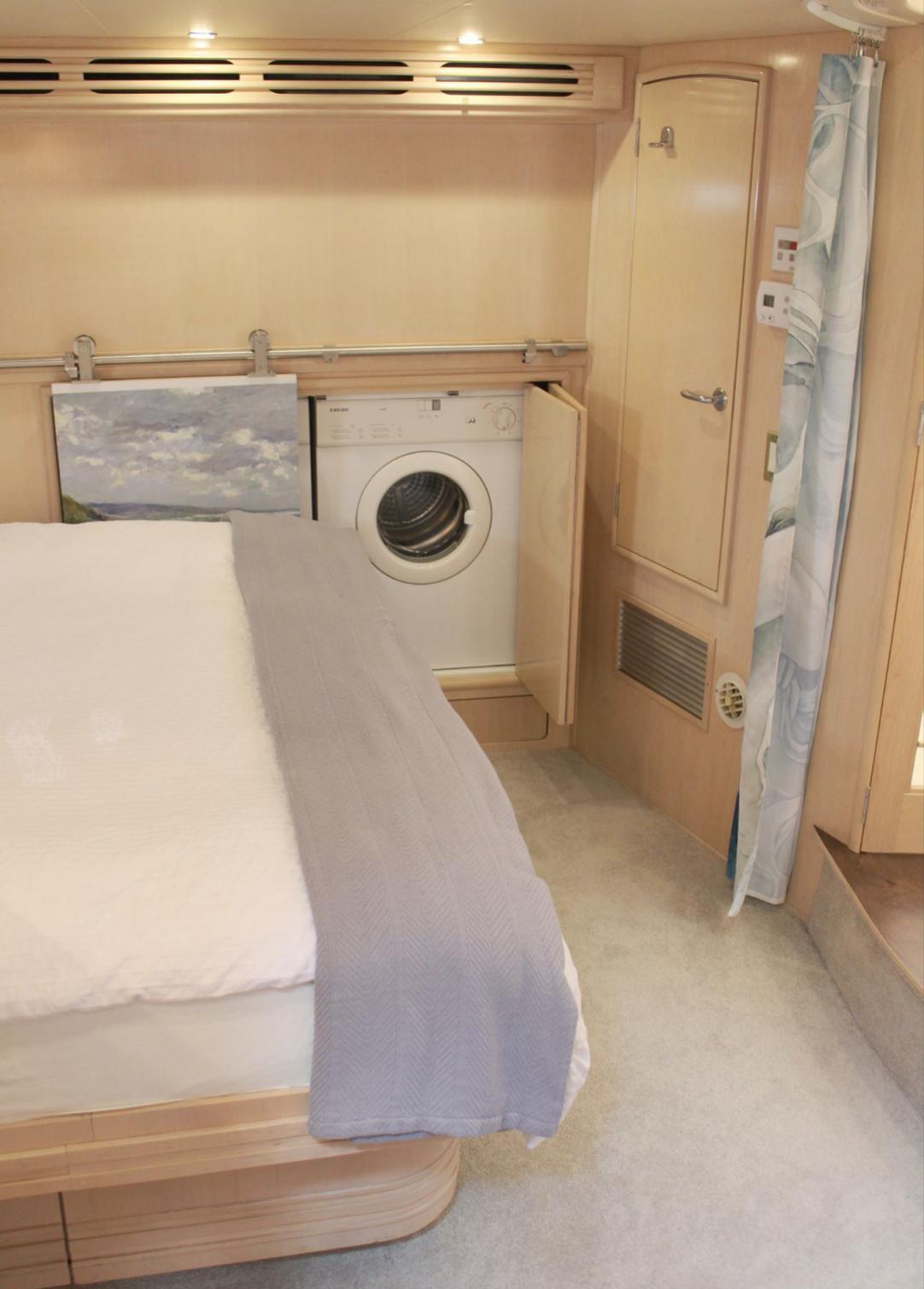 2000 Carver 530 Voyager Pilothouse interior with bed and built-in washing machine.