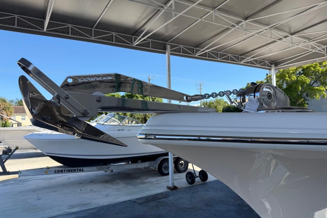 2026 Key West 239 FSR boat with anchor, parked under a canopy.