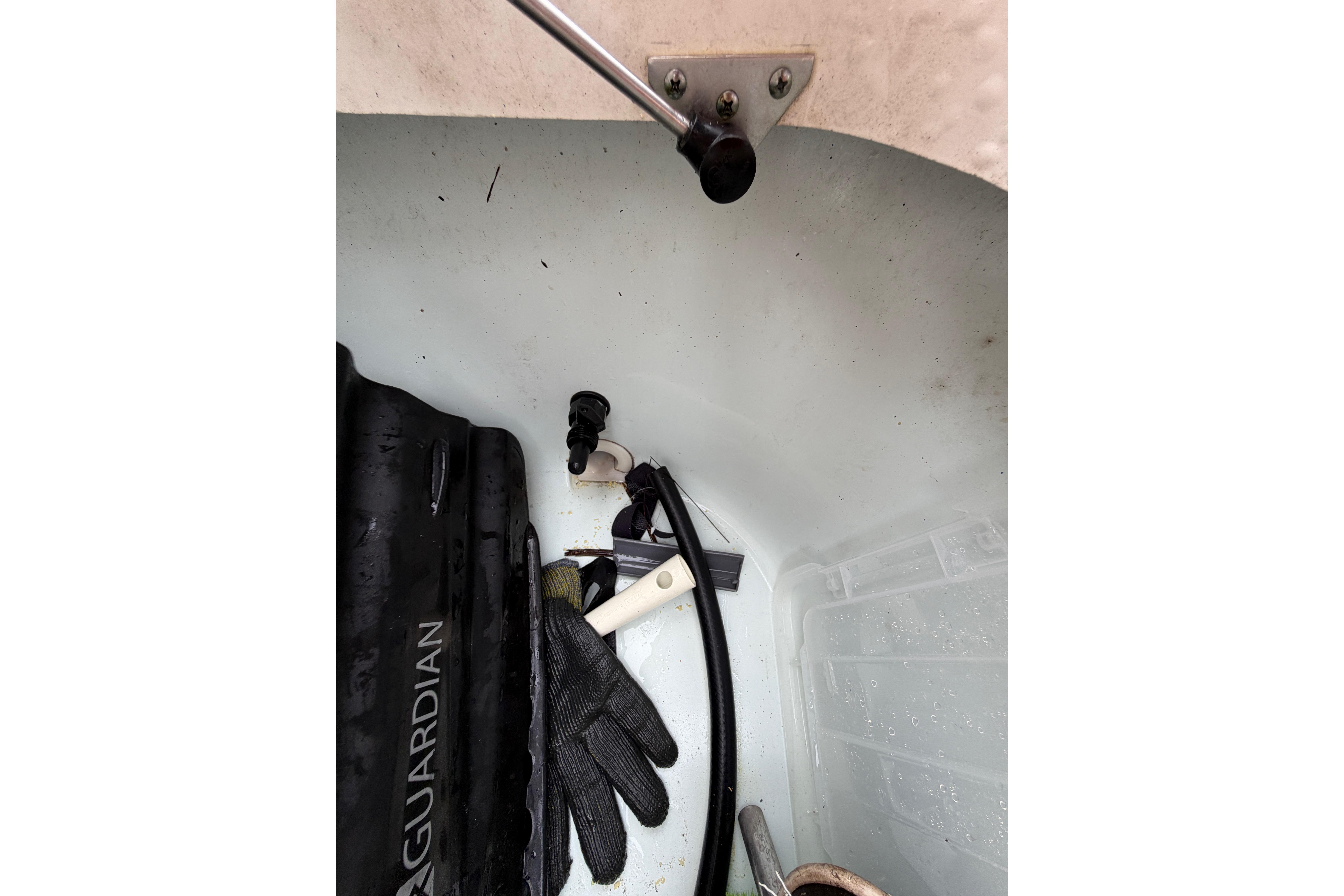 Storage compartment of 2019 World Cat 230 DC boat with gear and equipment.