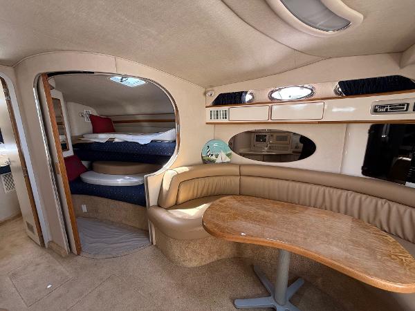Interior of 1995 Sea Ray 400 Express Cruiser with cozy seating and sleeping area.