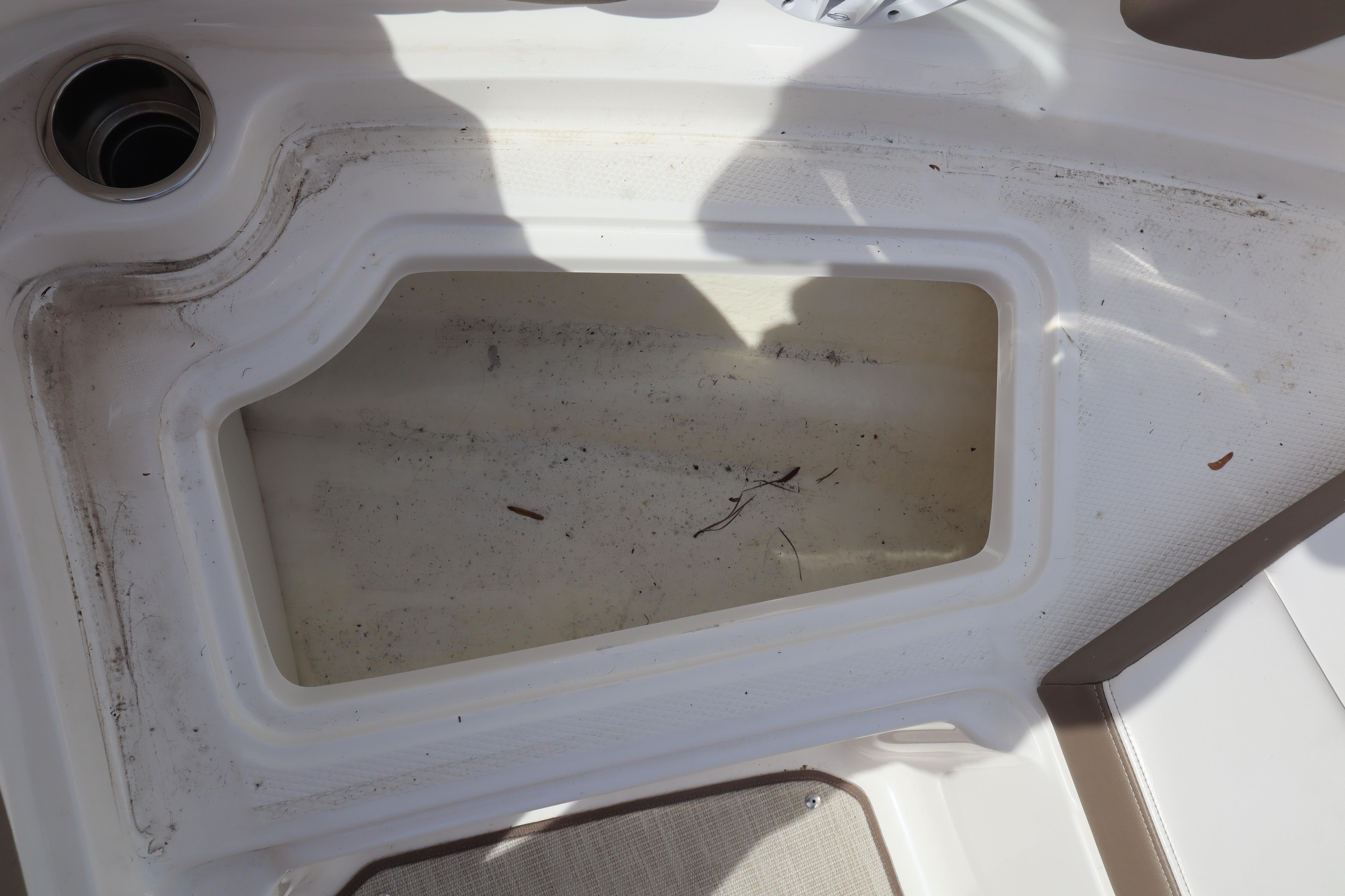Storage compartment on a 2021 Chaparral 21 SSi boat, showing interior details.