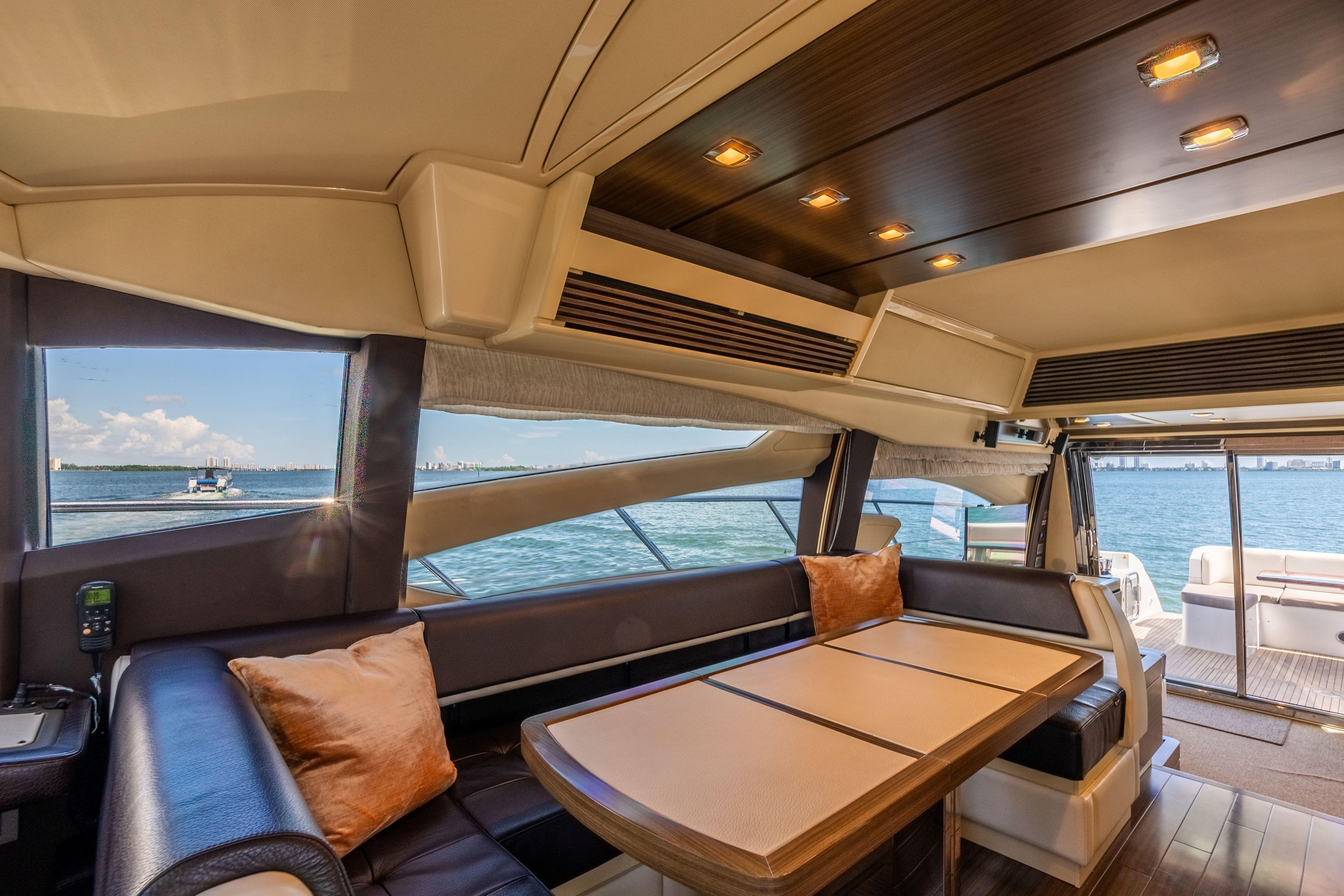 Luxurious interior of 2016 Azimut 64 Flybridge yacht with ocean view.
