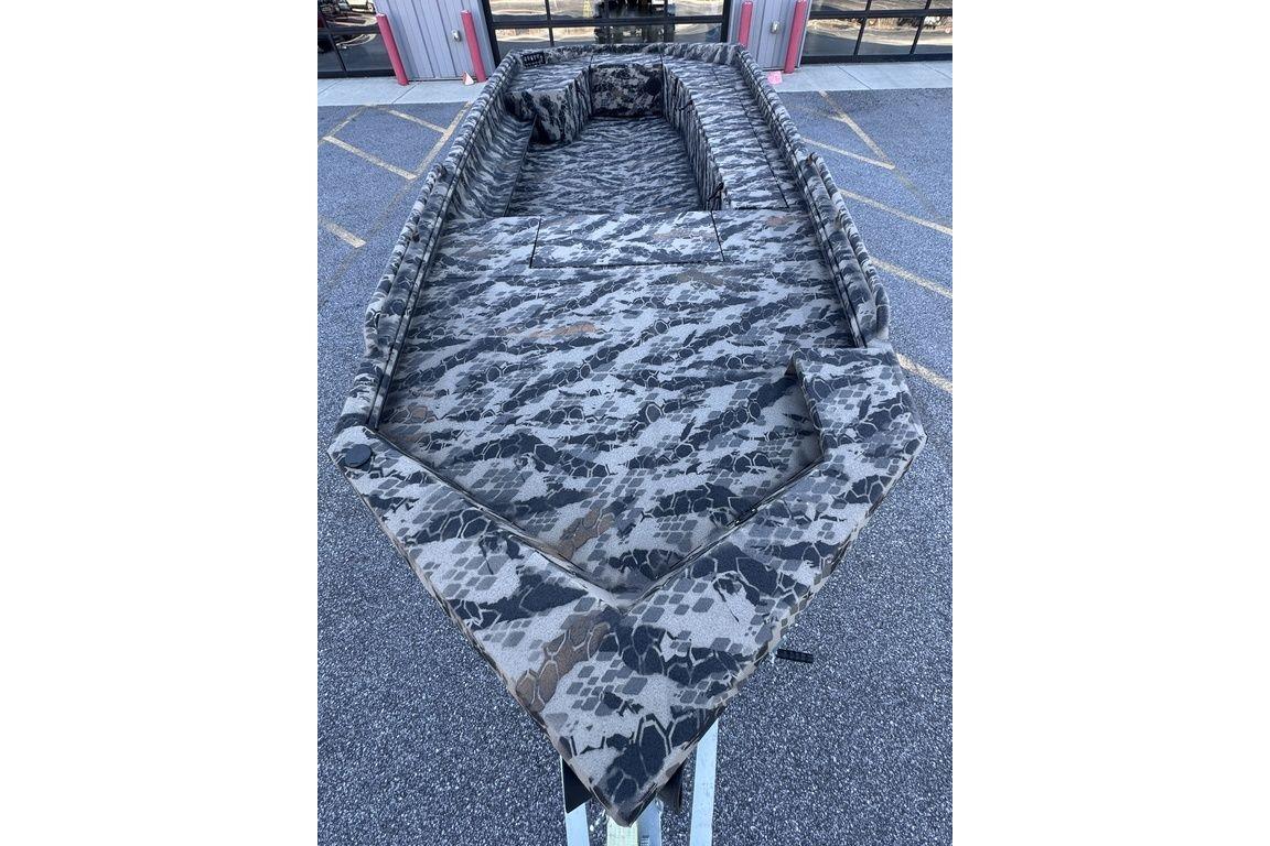 Camouflage interior of 2025 Havoc 1860 boat, parked outdoors.