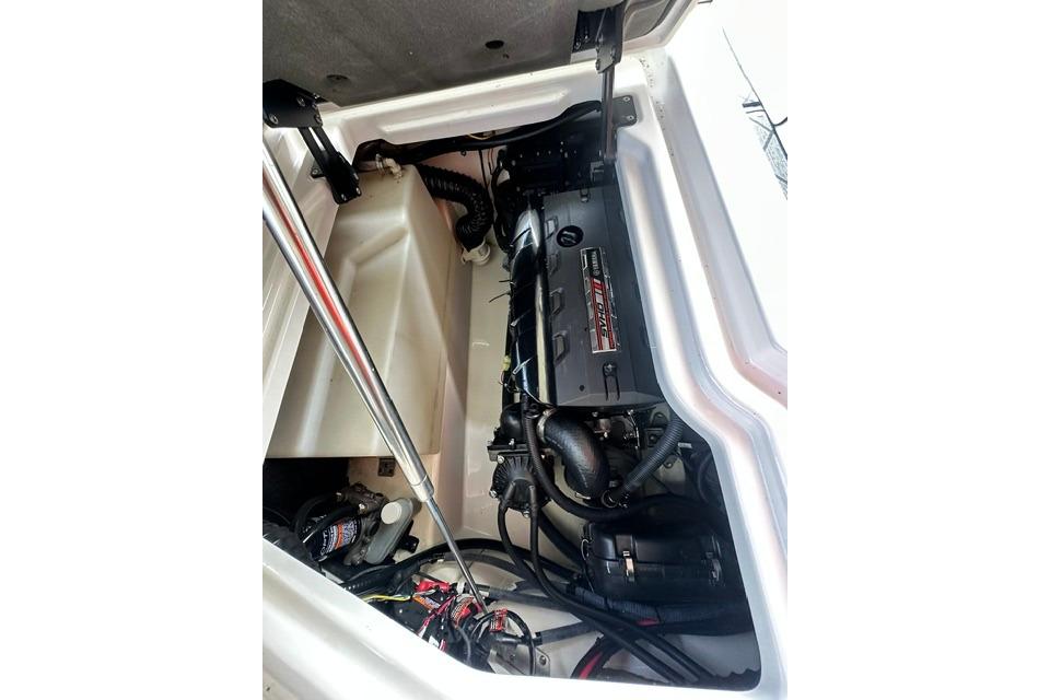 Engine compartment of a 2021 Yamaha Boats 275SD, showcasing mechanical components and wiring.