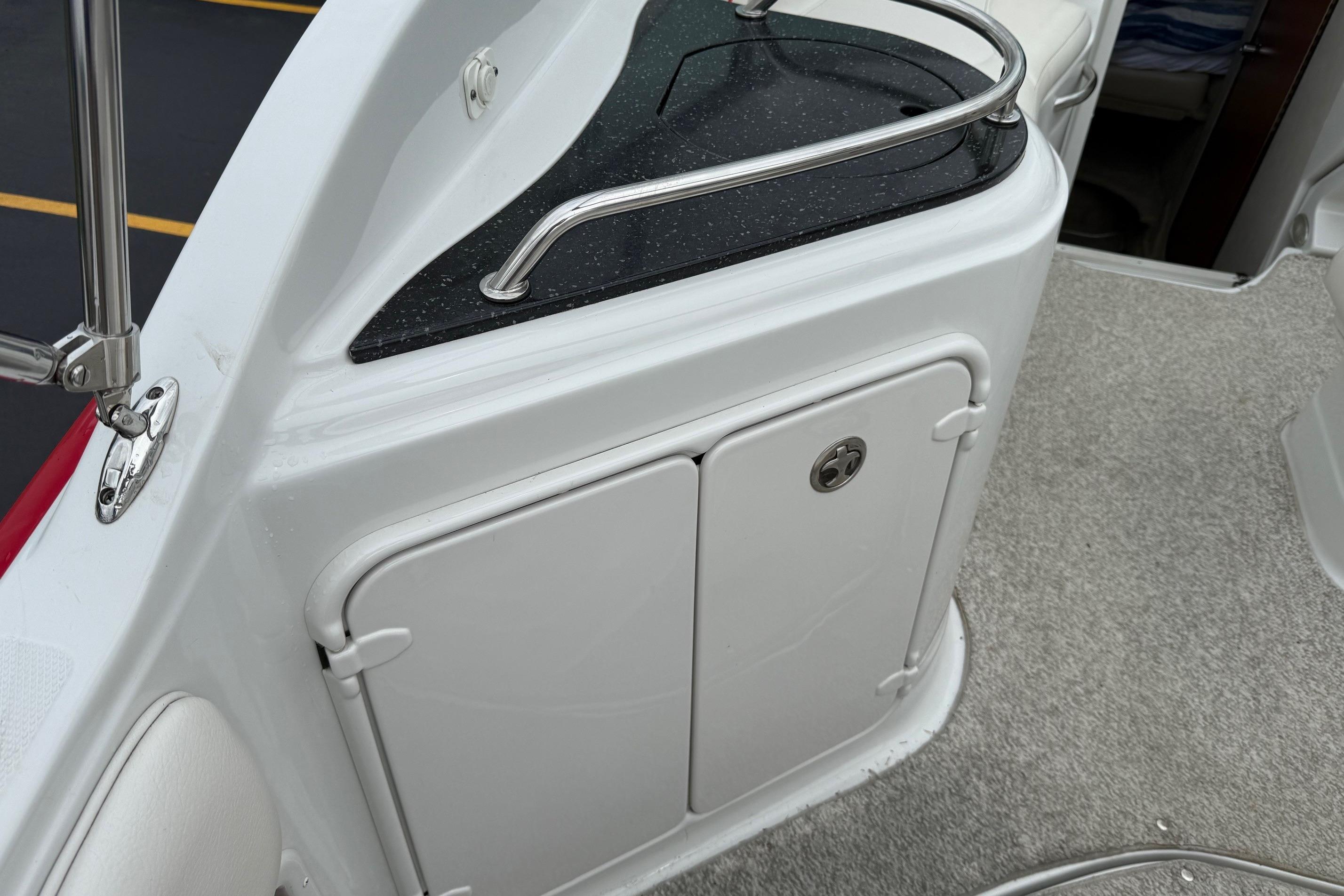 2005 Crownline 250 CR boat interior with storage compartment and sleek design.