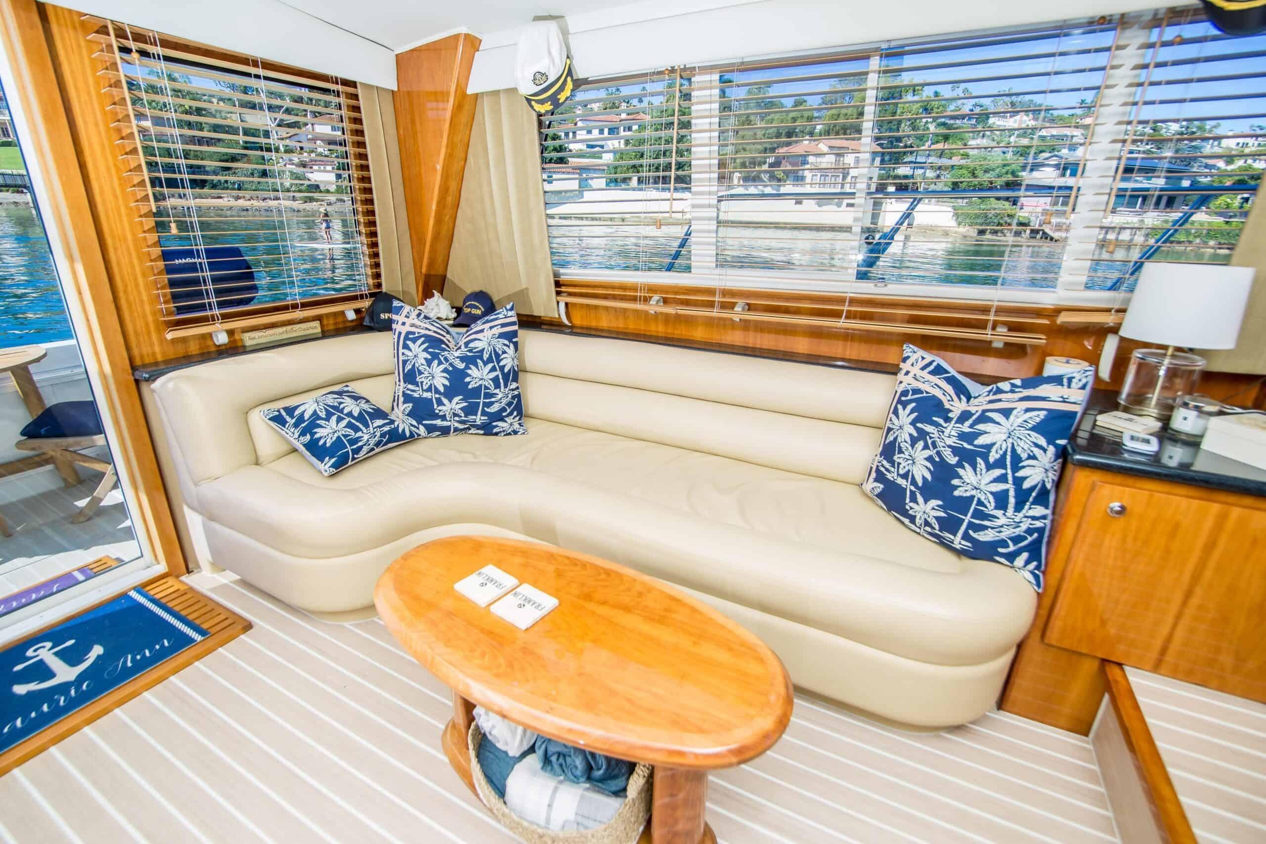 Luxurious interior of 2005 Navigator 4400 Pilothouse yacht with plush seating and nautical decor.