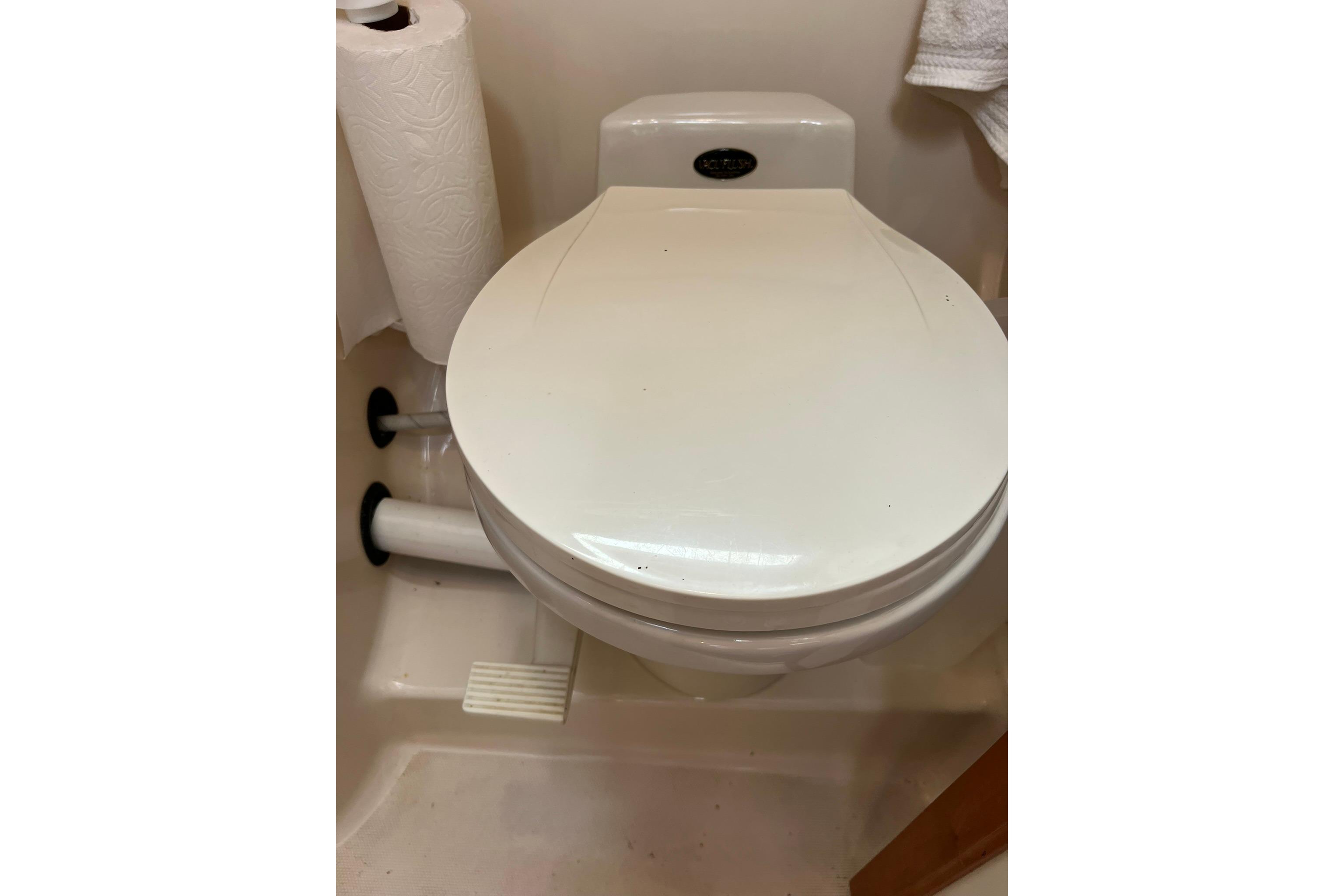 1998 Sabre 362 marine toilet with paper holder in compact bathroom setting.