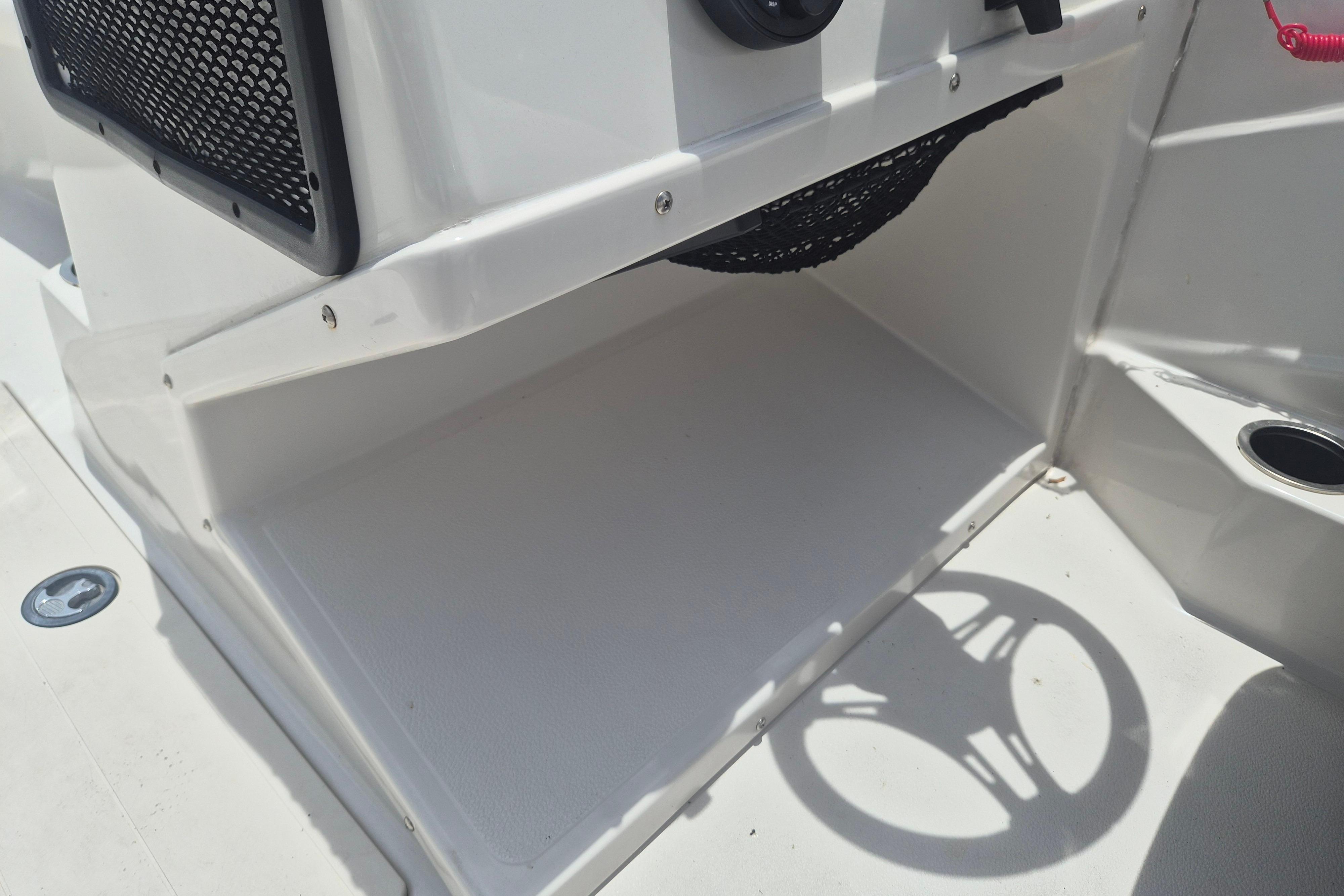 Storage compartment in a 2022 Starcraft SVX 171 OB boat, featuring a netted shelf.