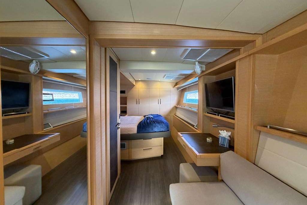 Luxurious interior of 2019 Lagoon 630 MY yacht with modern furnishings and cozy bedroom.