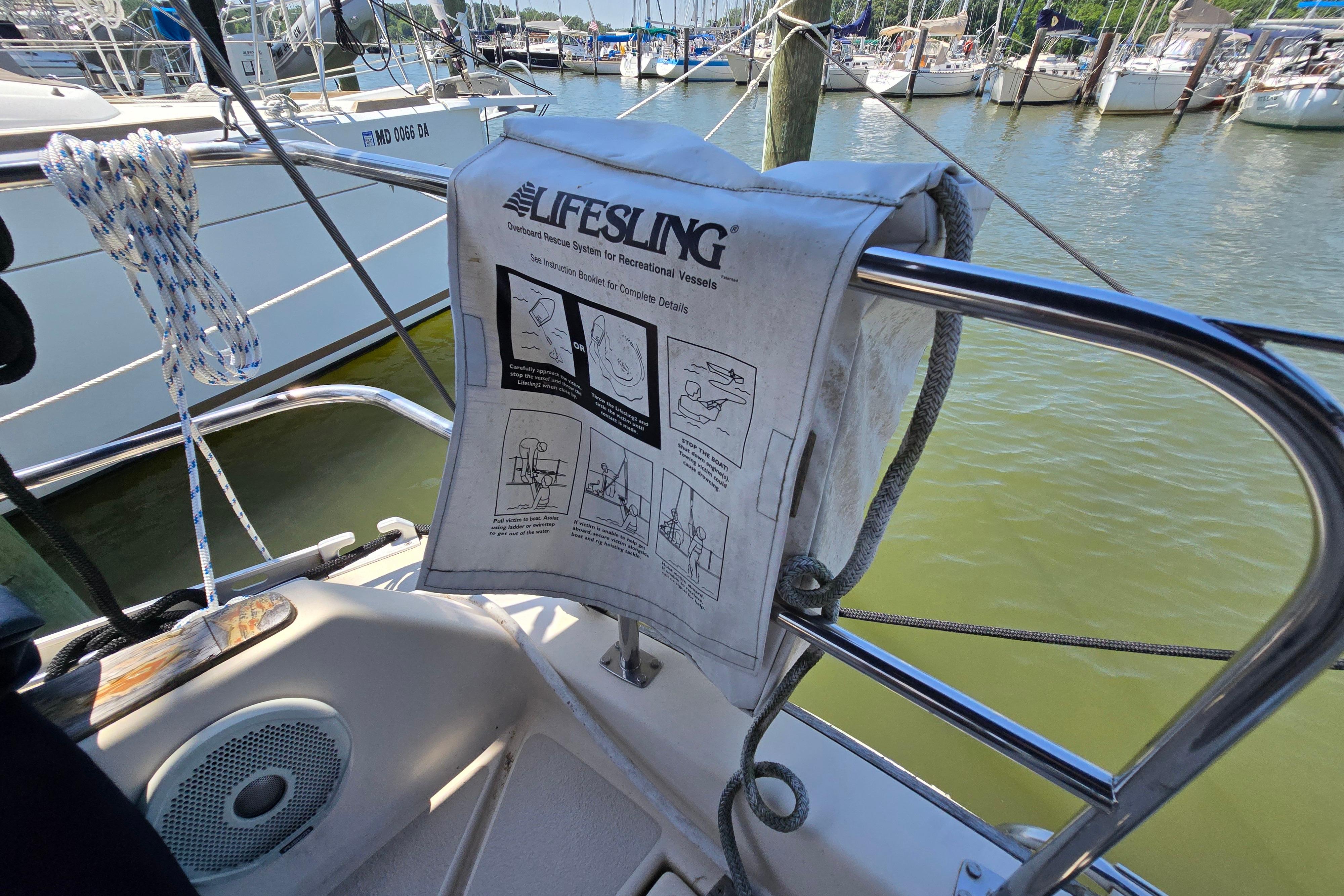 Lifesling rescue system on 1993 Caliber 35 sailboat, docked in marina.