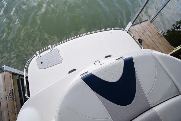 The image shows the stern of a 2010 Bryant 255 boat docked at a pier.