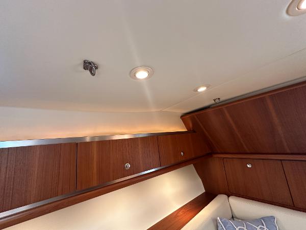 Interior of 2006 Tiara Yachts 3200 Open, featuring wooden cabinetry and recessed lighting.