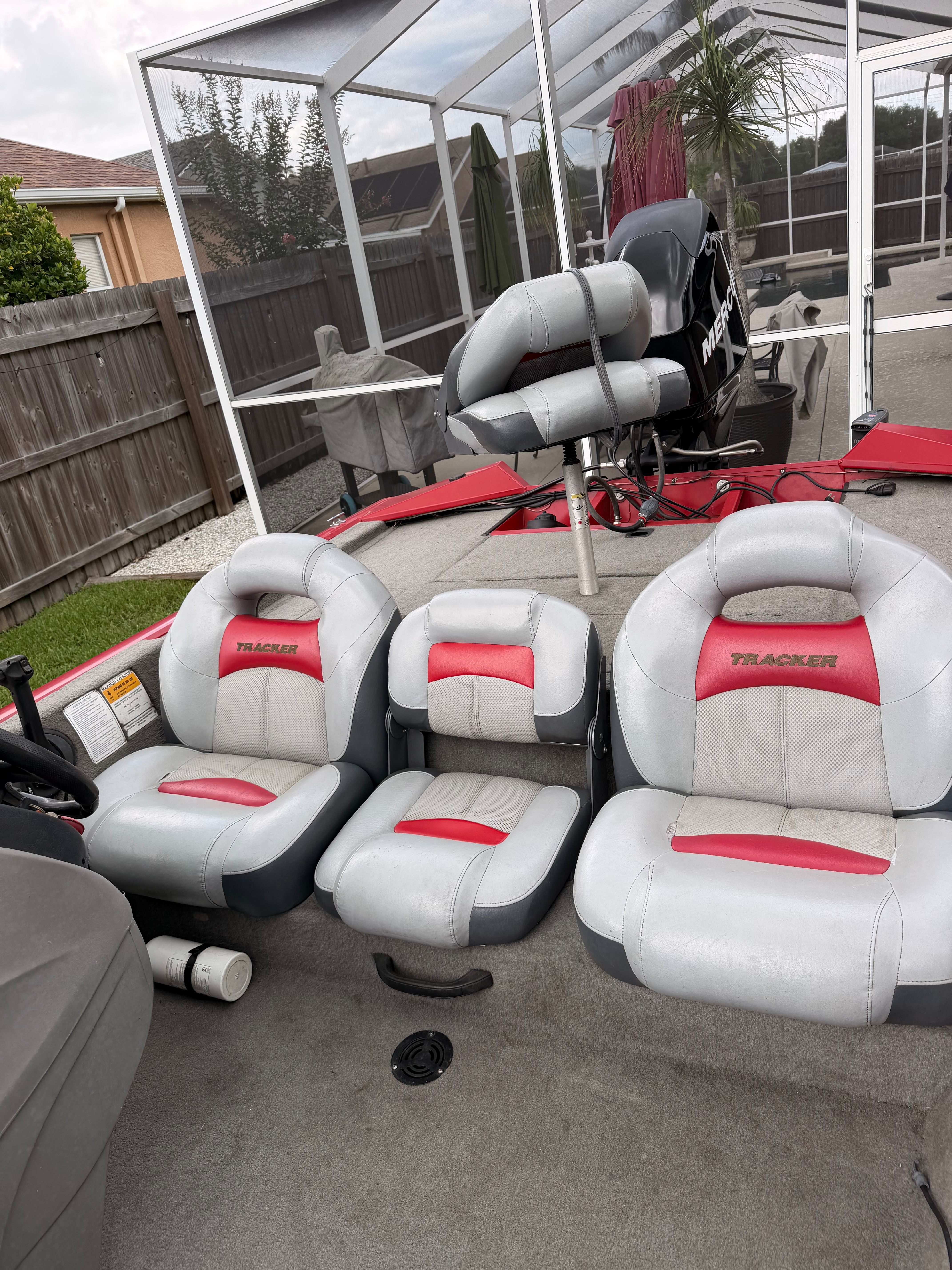 Interior of a 2011 Bass Tracker PRO TEAM 175 TXW with gray and red seats.